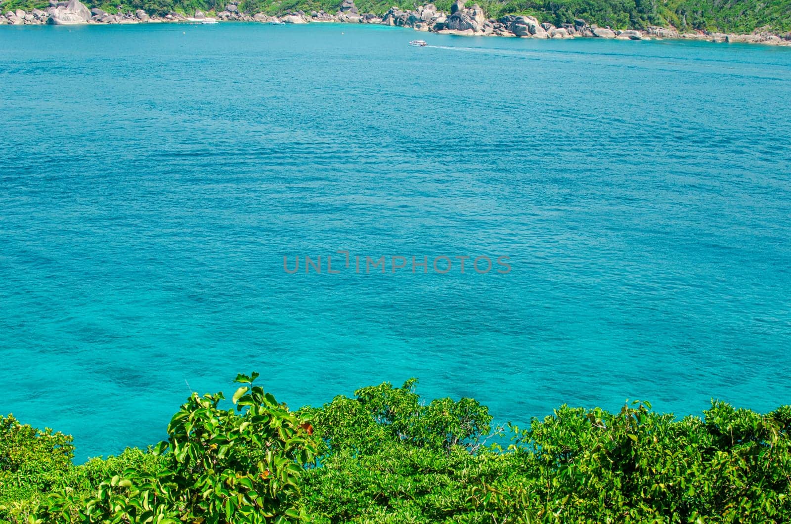 Tropical islands of ocean blue sea water and white sand beach at Similan Islands with famous Sail Rock, Phang Nga Thailand nature landscape. High quality photo