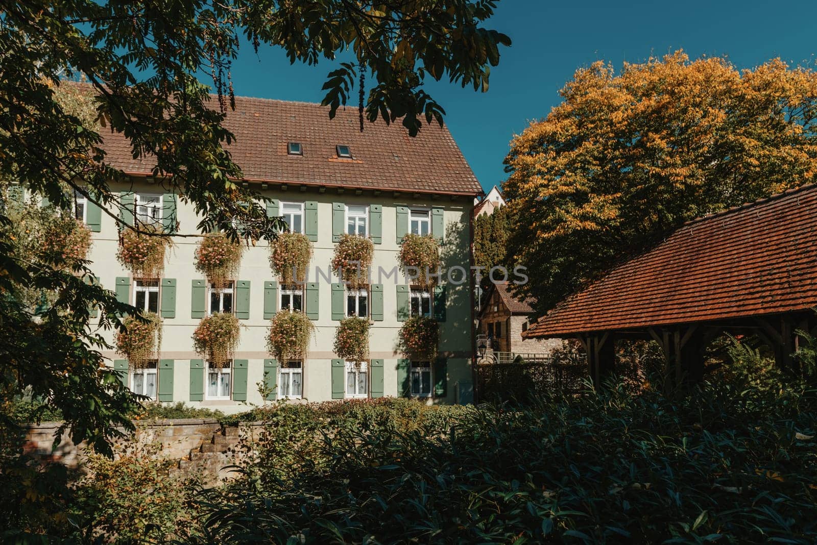 Old national German town house. Old Town is full of colorful and well preserved buildings. Baden-Wurttemberg is a state in southwest Germany bordering France and Switzerland. The Black Forest, known for its evergreen scenery and traditional villages, lies in the mountainous southwest. Stuttgart, the capital, is home to Wilhelma, a royal estate turned zoo and gardens. Porsche and Mercedes-Benz have headquarters and museums there. The 19th-century Hohenzollern Castle sits in the Swabian Alps to the south.