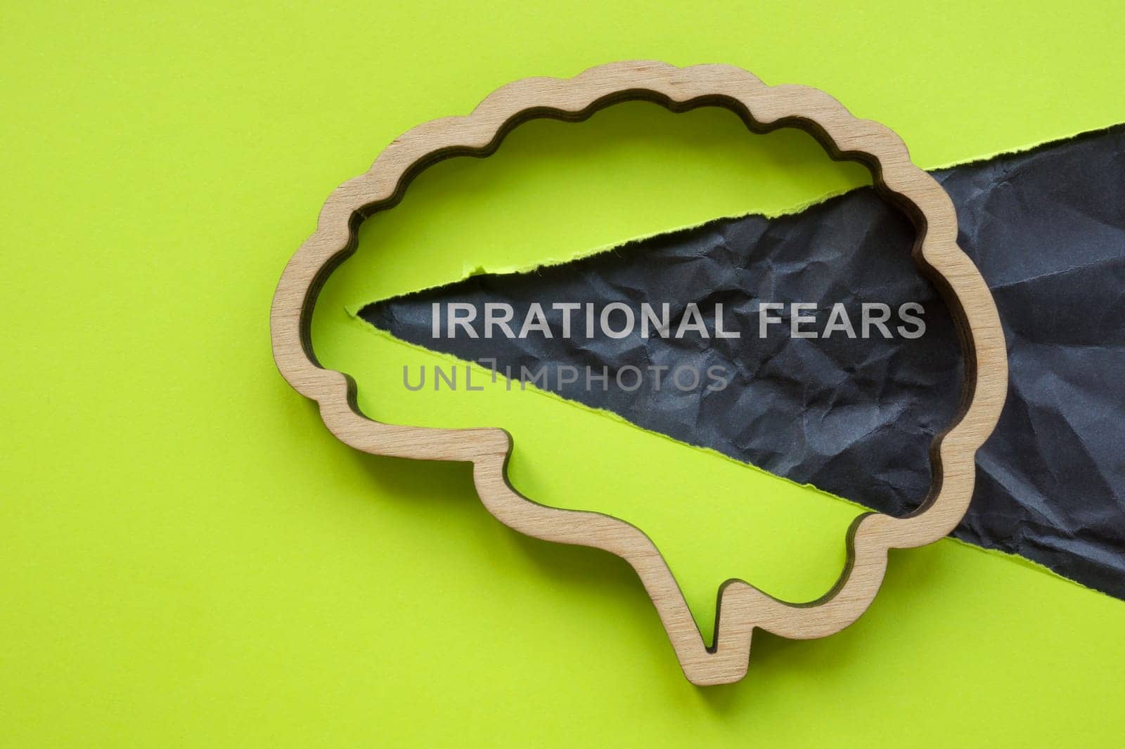 Irrational fears. Outline of the brain and a torn piece of paper. by designer491