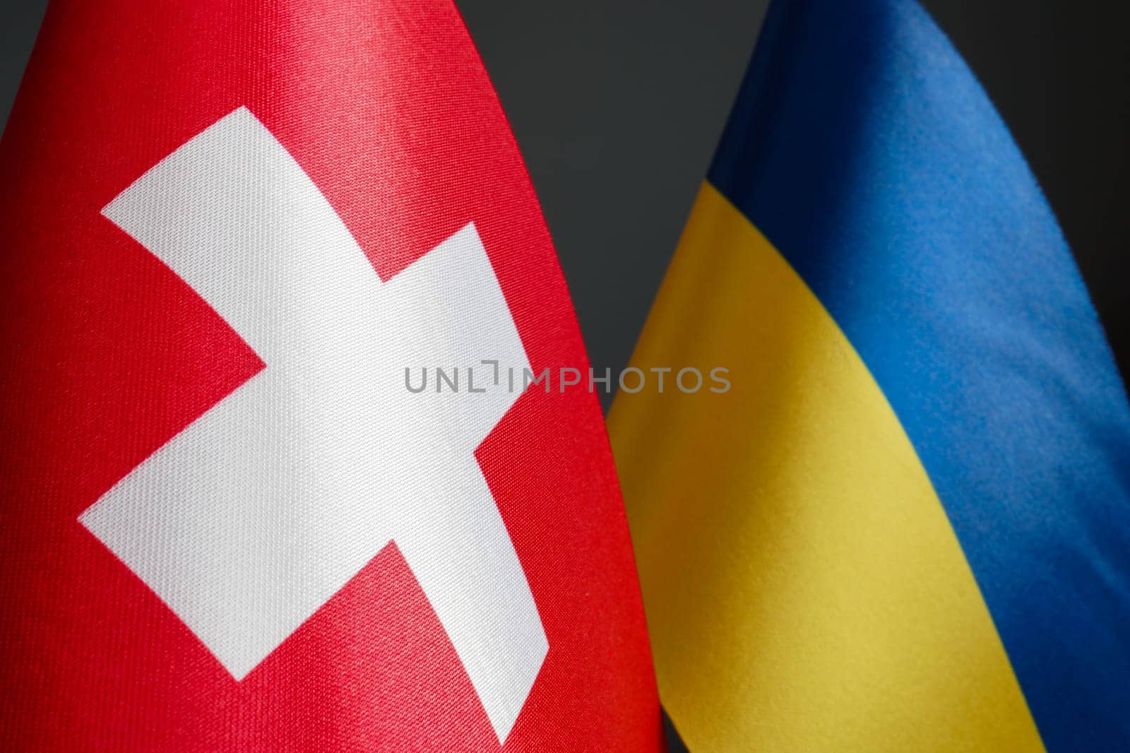 Nearby are small flags of Switzerland and Ukraine. by designer491