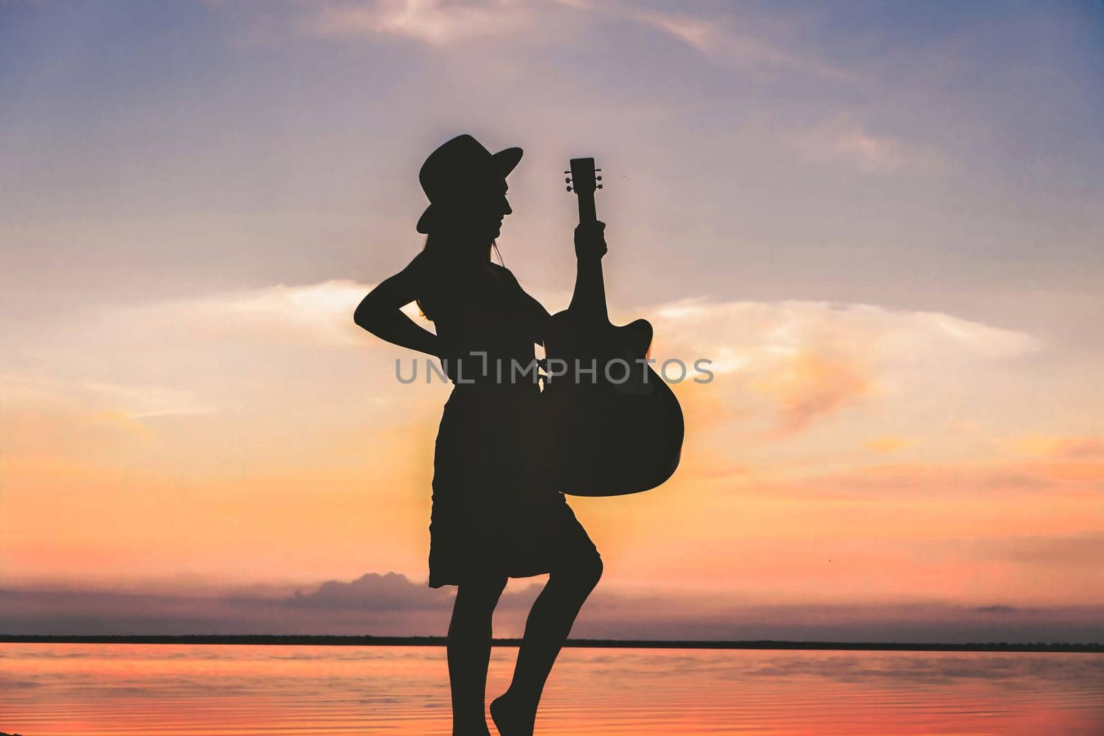 Woman and guitar with sunset silhouette download by igor010