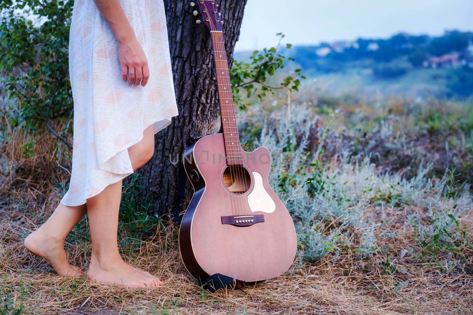 Beautiful romantic background with guitar outdoor. Photo of sensual woman. Art work. Music background download by igor010