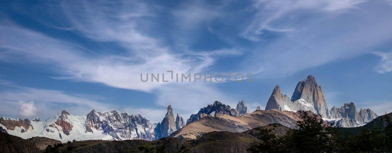 Majestic Mountain Peaks under a Whispy Blue Sky by FerradalFCG