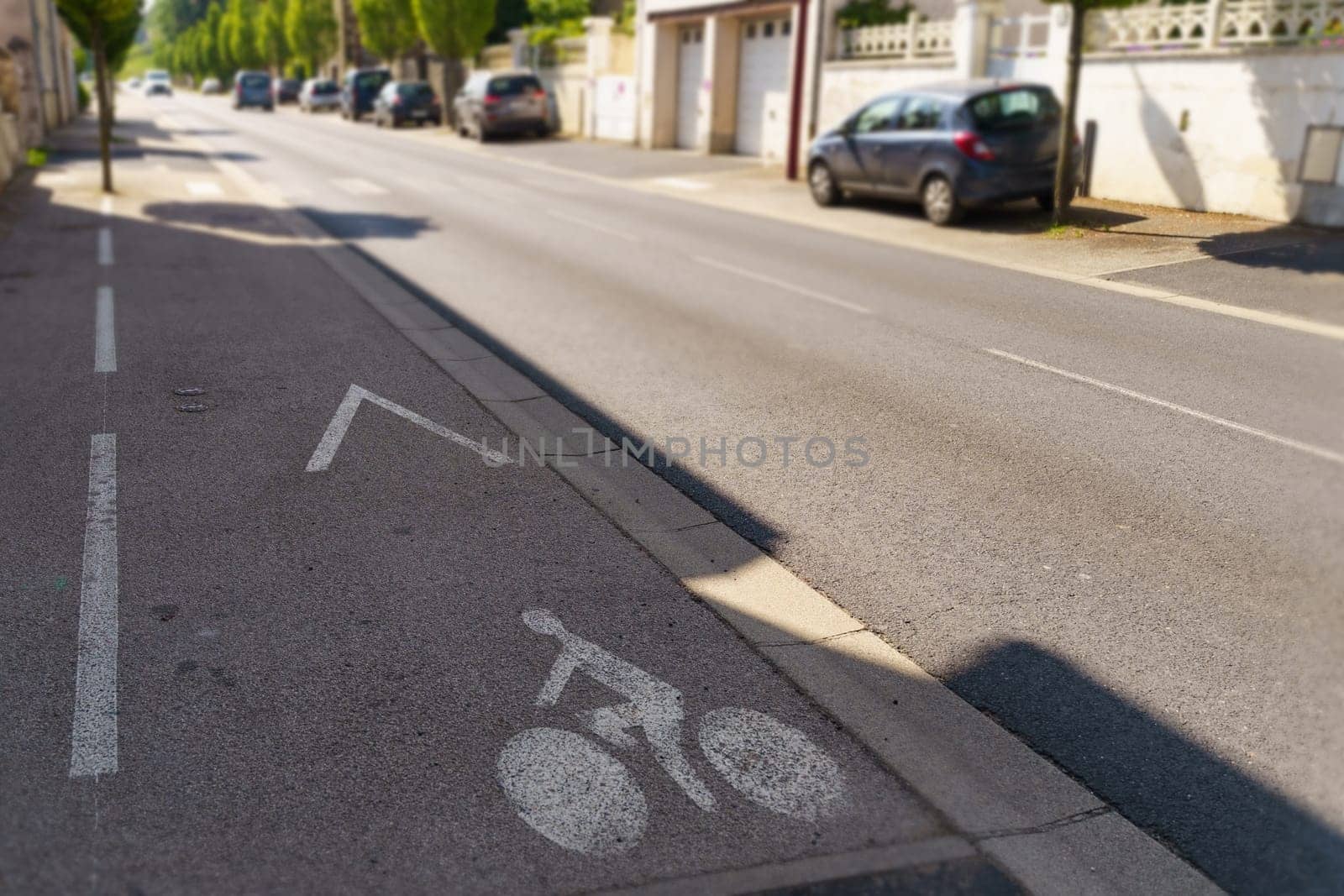 A designated lane for bicycles separated from vehicular traffic by a marked line on the side of a city street.