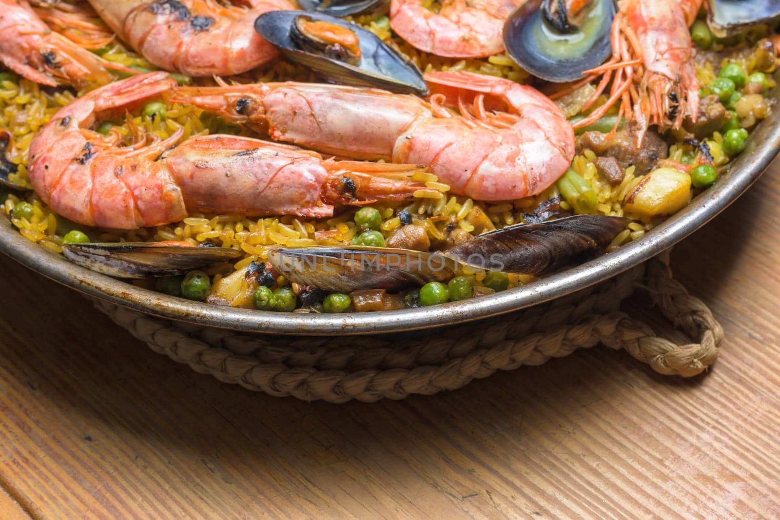 Aromatic shrimp paella with peas and mussels, rich in Mediterranean flavors, typical Spanish cuisine, Majorca, Balearic Islands, Spain,