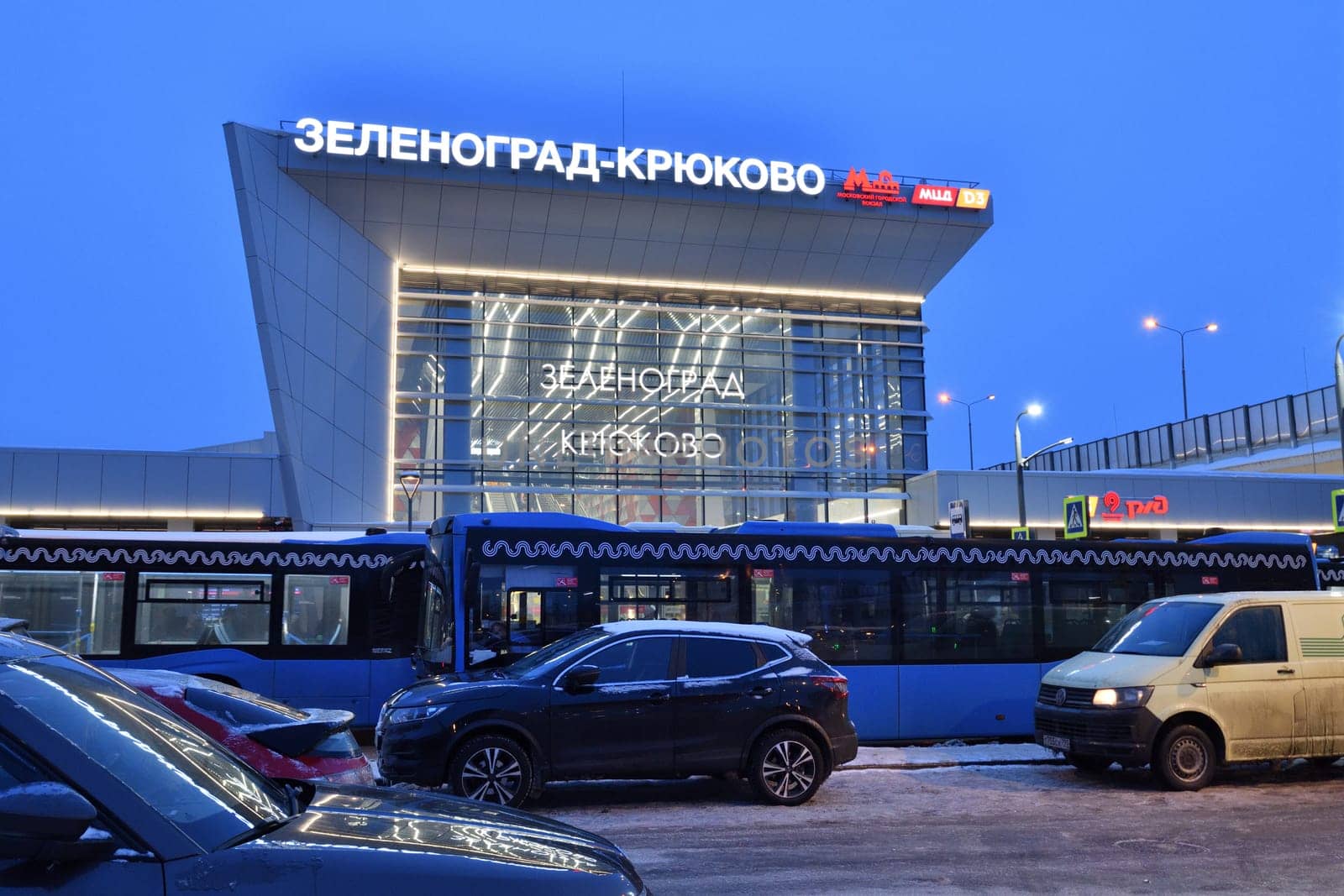 Moscow, Russia - Feb 14. 2024. Bus before Moscow Central Diameter D3 - railway lines that form single transport system with subway. Station Zelenograd - Kryukovo by olgavolodina