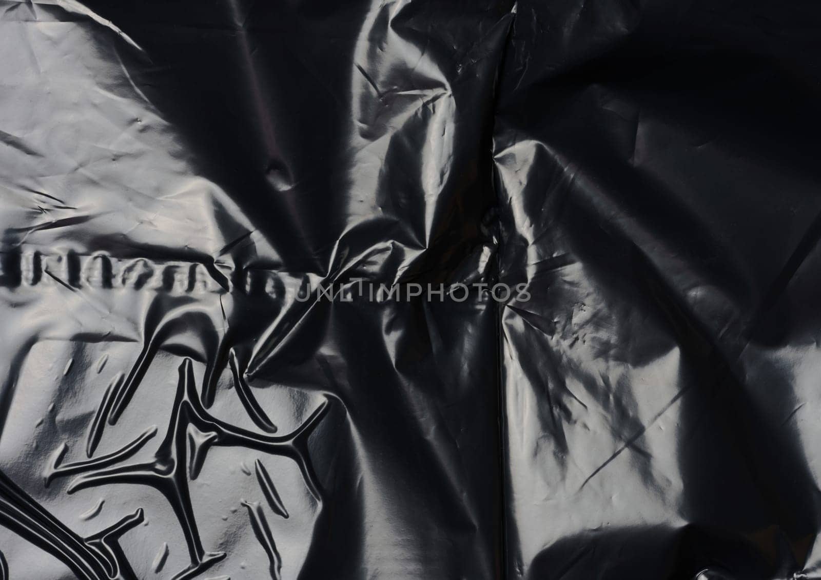 Texture of black crumpled cellophane by ndanko