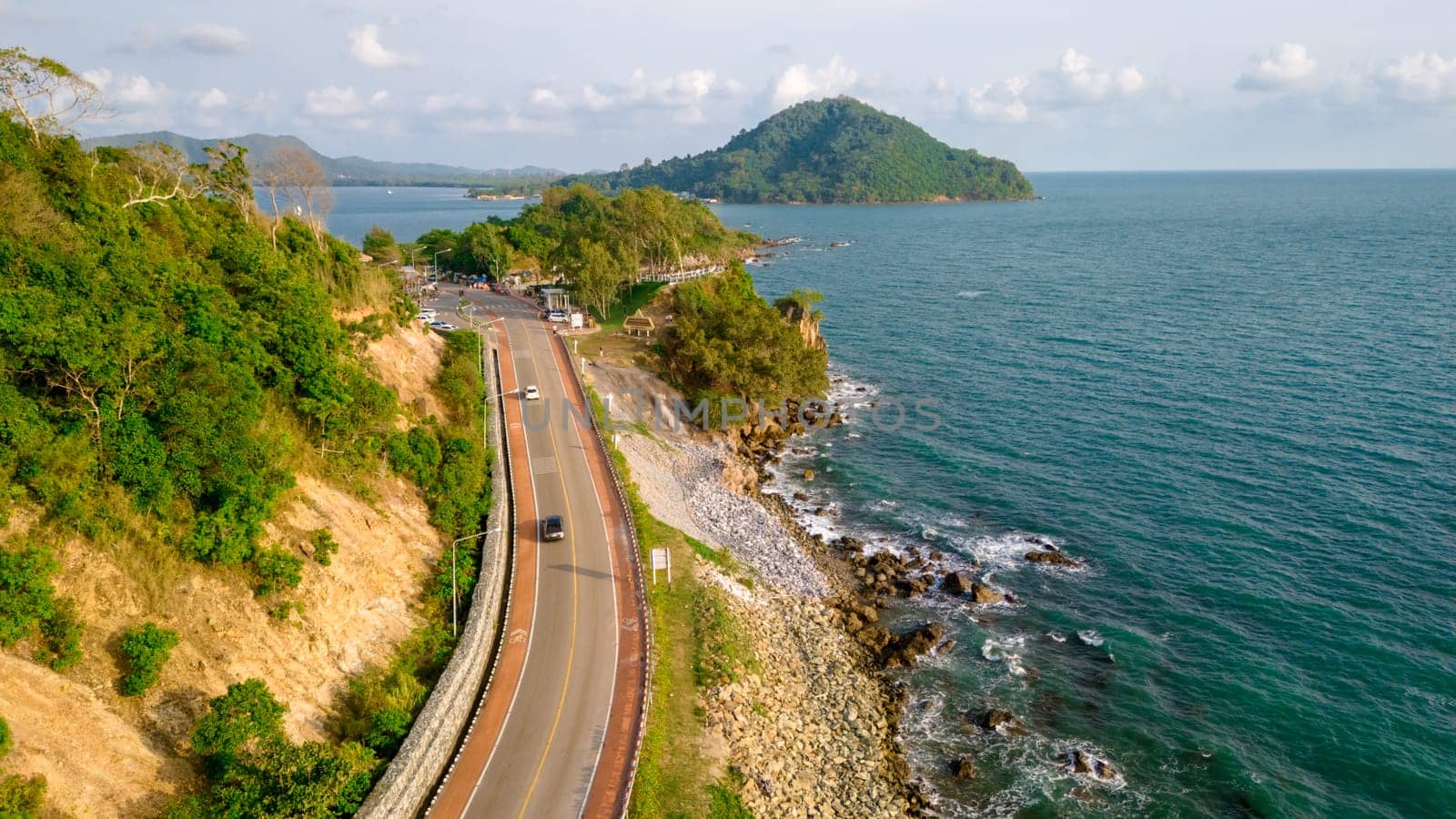 car driving on the curved road of Thailand. road landscape in summer. it's nice to drive on the beachside highway. Chantaburi Province Thailand at sunset