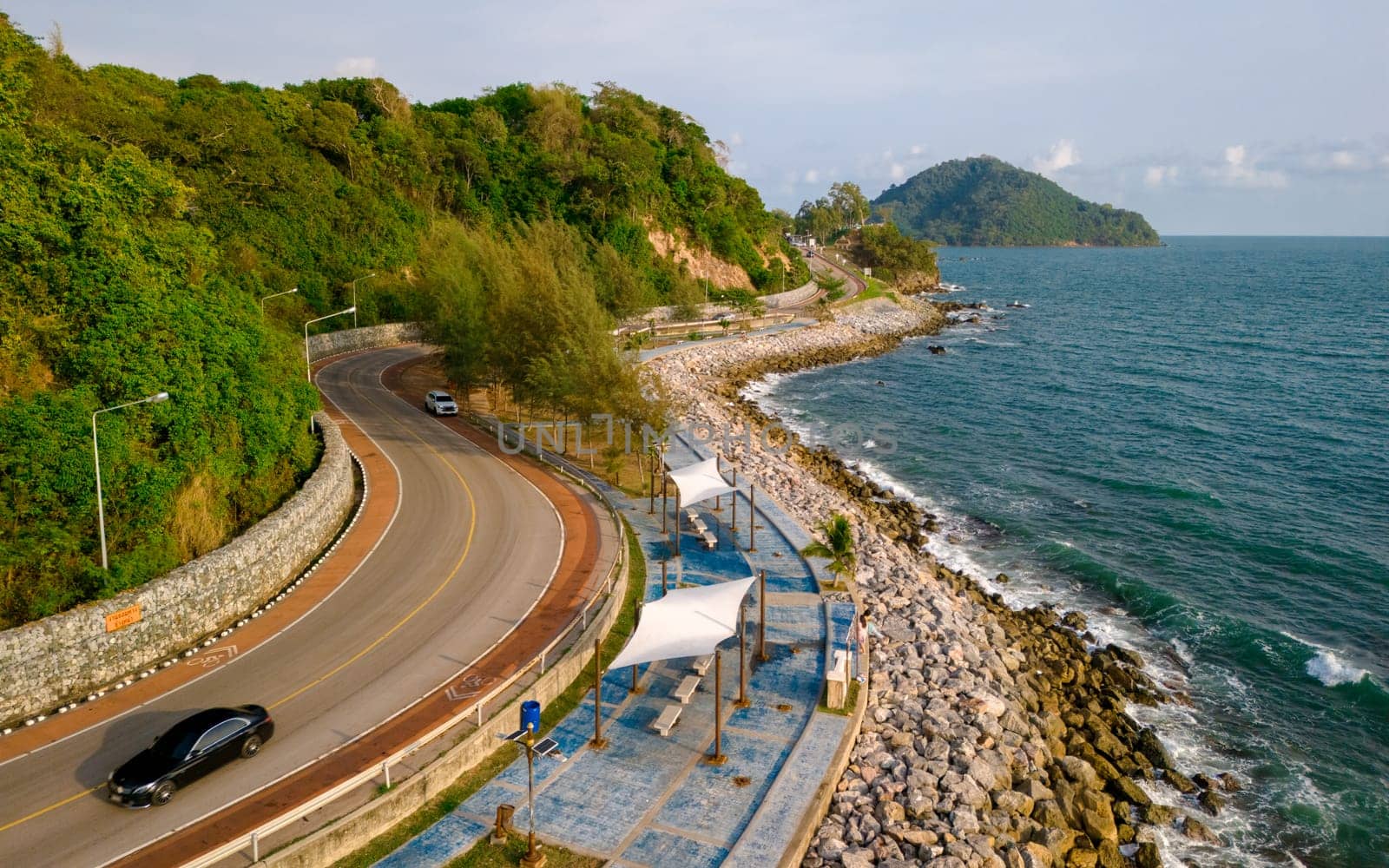 car driving on the curved road of Thailand. road landscape in summer. it's nice to drive on the beachside highway. Chantaburi Province Thailand, car on the road at the beach side