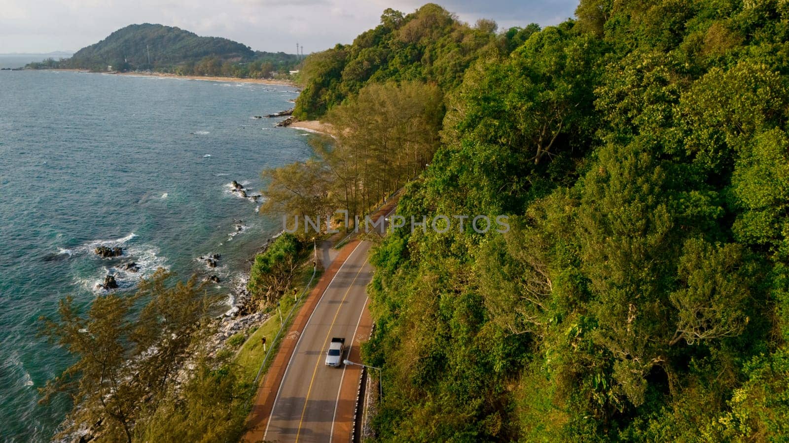 car driving on the curved road of Thailand. road landscape in summer. it's nice to drive on the beachside highway. Chantaburi Province Thailand, mountain ocean road