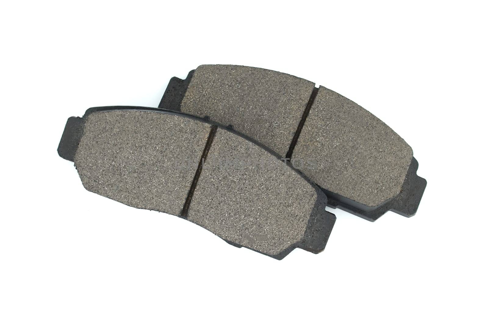 New auto brake pads isolated on white background by NetPix