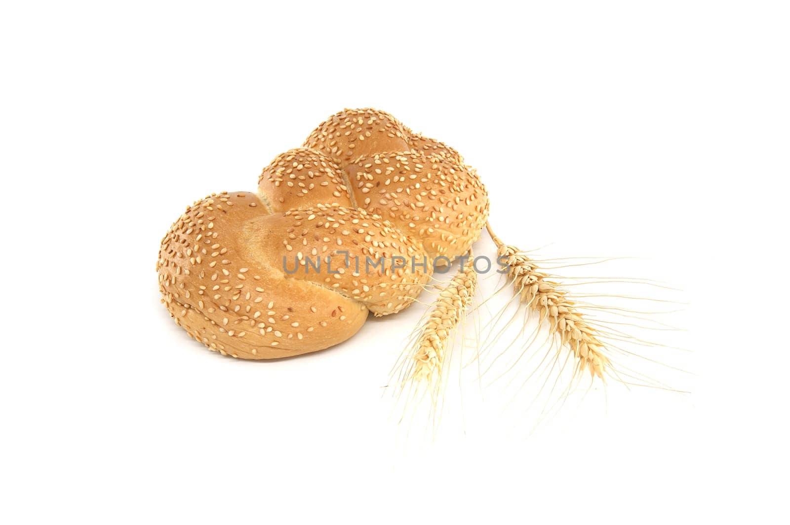Golden braided sesame bread and a stalks of wheat by NetPix