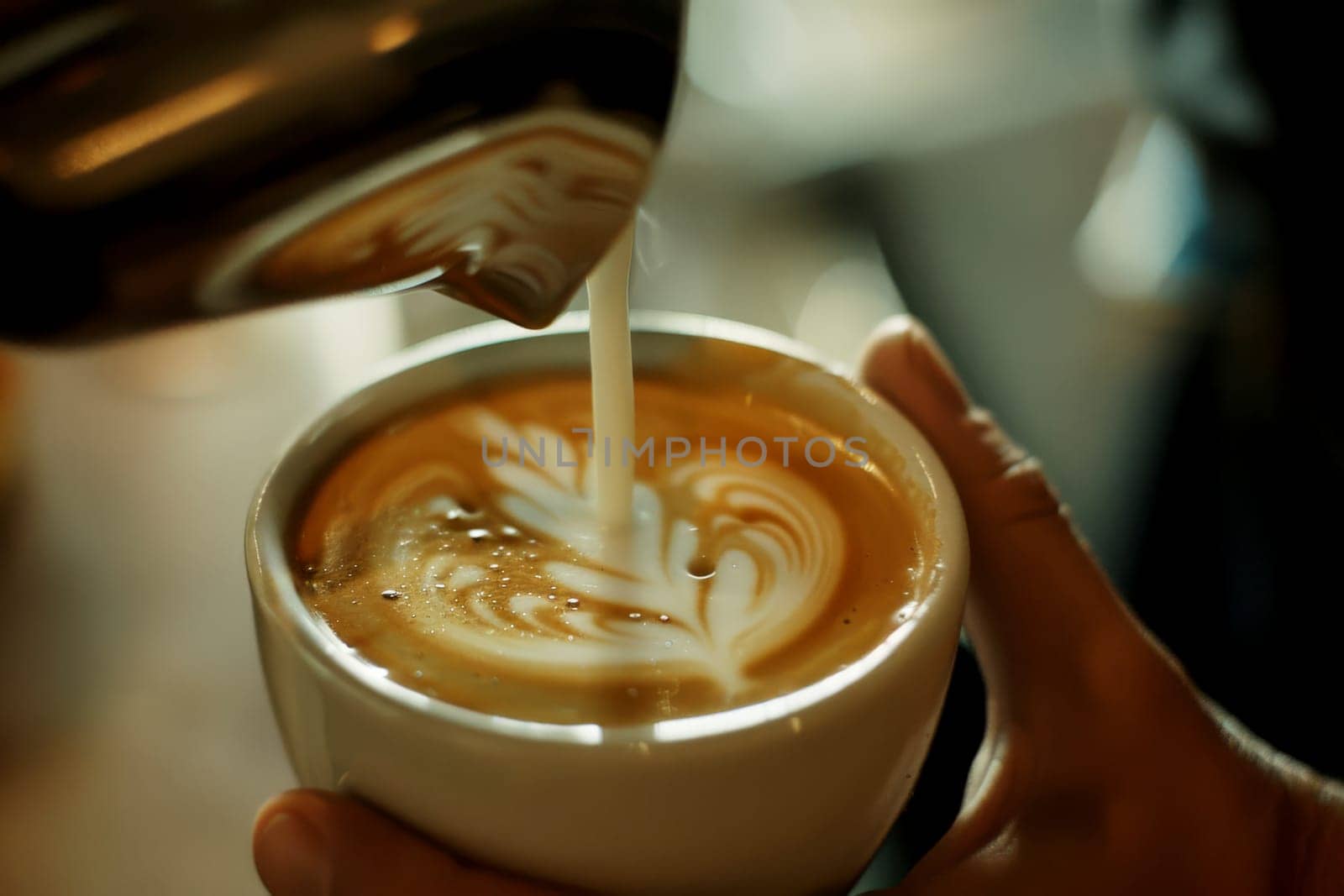 vintage tone of some people pour milk to making latte art coffee at cafe or coffee shop.