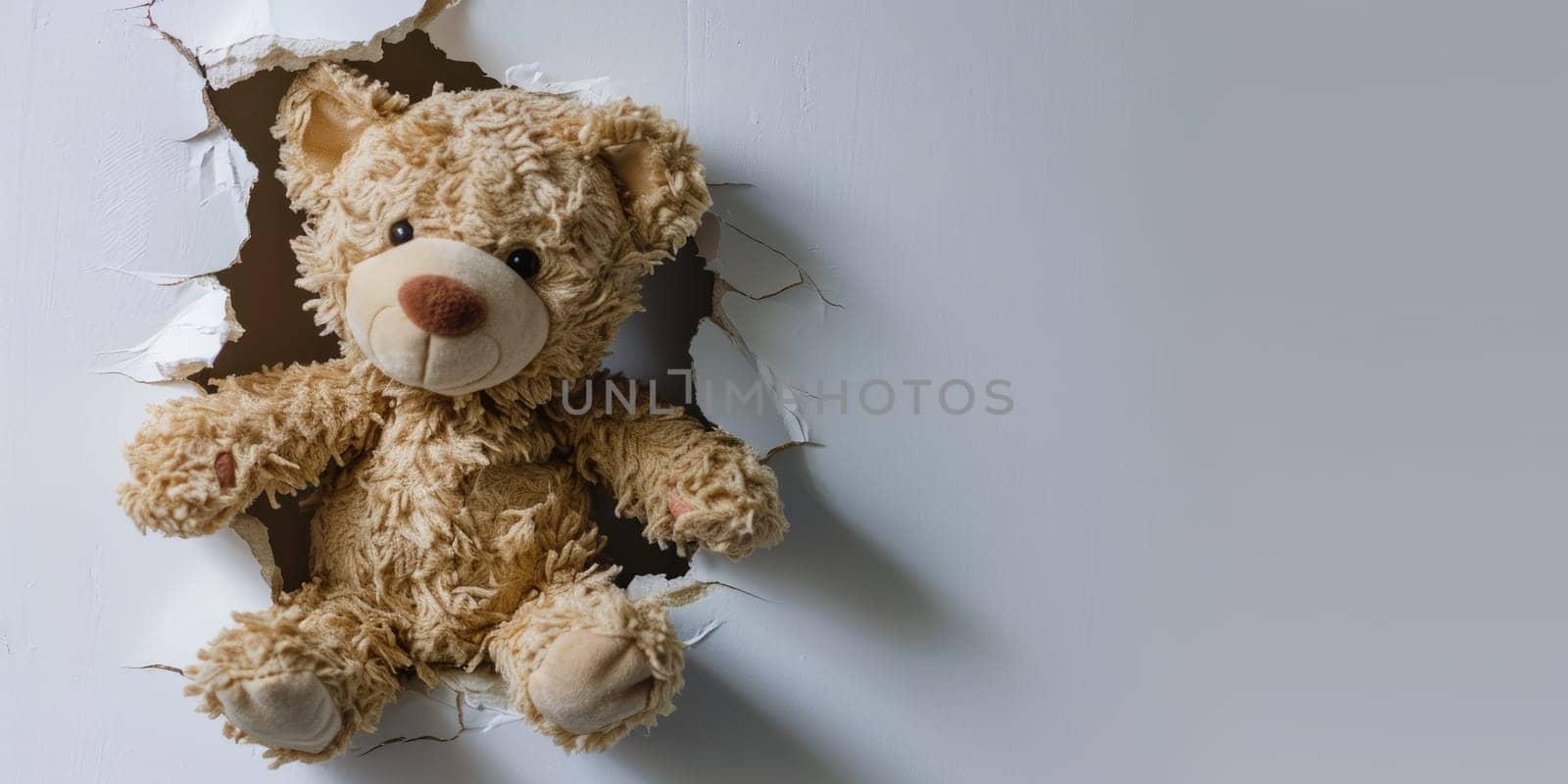 Close up view picture of the hollow white hole on the the wall that show the teddy stay inside the wall that has been made from some material yet still can be break to look through other side. AIGX03.