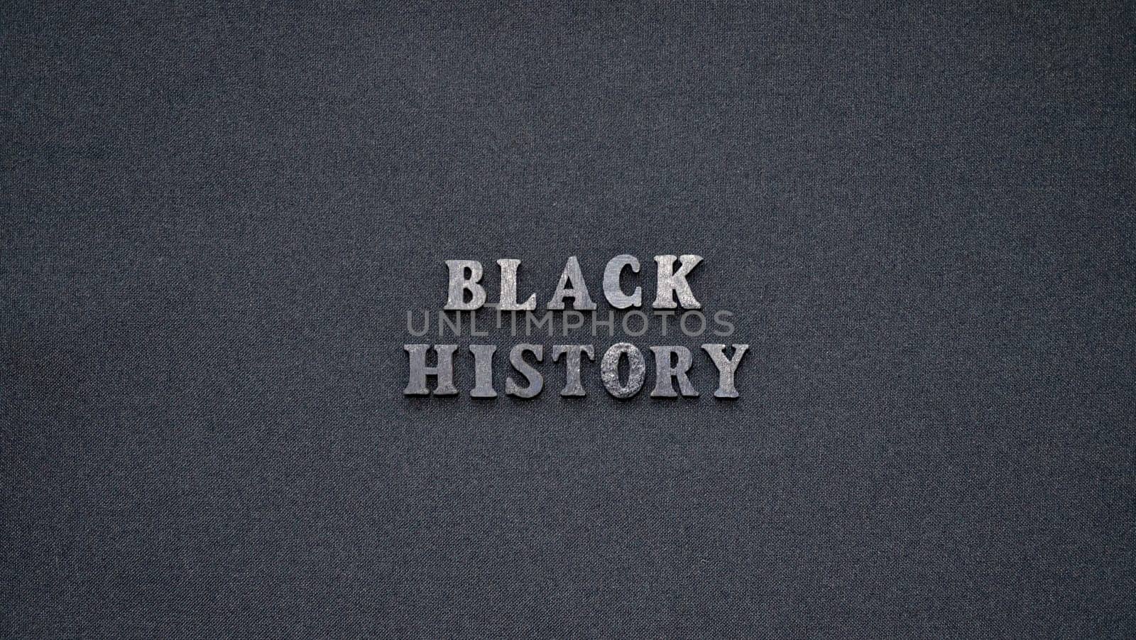 Inscription text Black History Month on dark isolated background close up. Celebrating the African American Conceptual Holiday for Equality