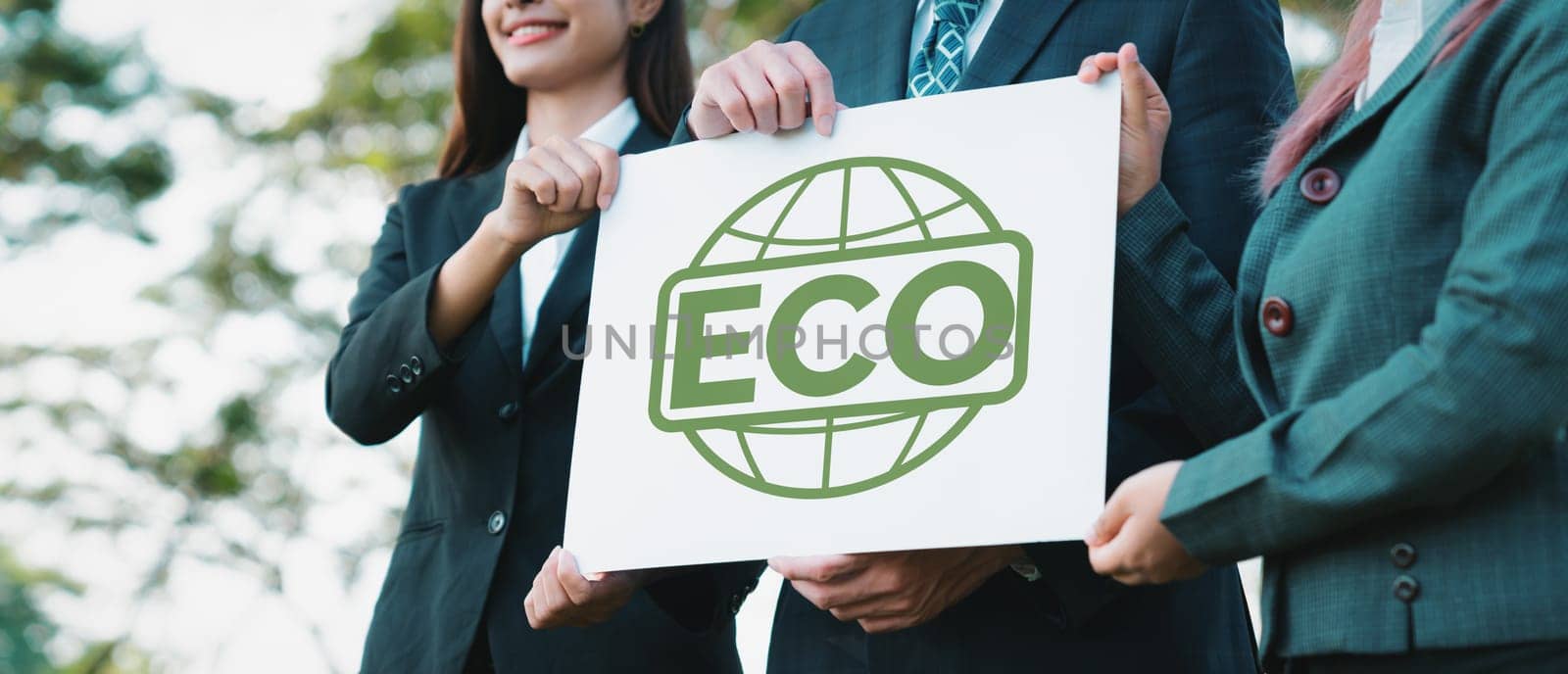 Group of business people stand united, holding eco-friendly idea and concept for environmental awareness campaign embracing eco friendly and greener environment with inspire positive change.Gyre