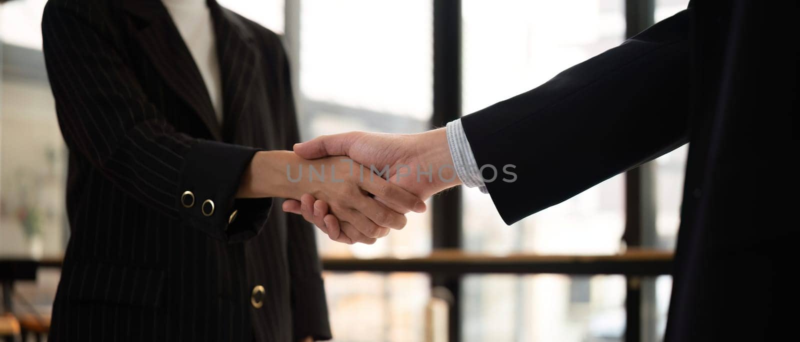 Businessmen shake hands after a meeting, congratulating colleagues and reaching a business agreement..