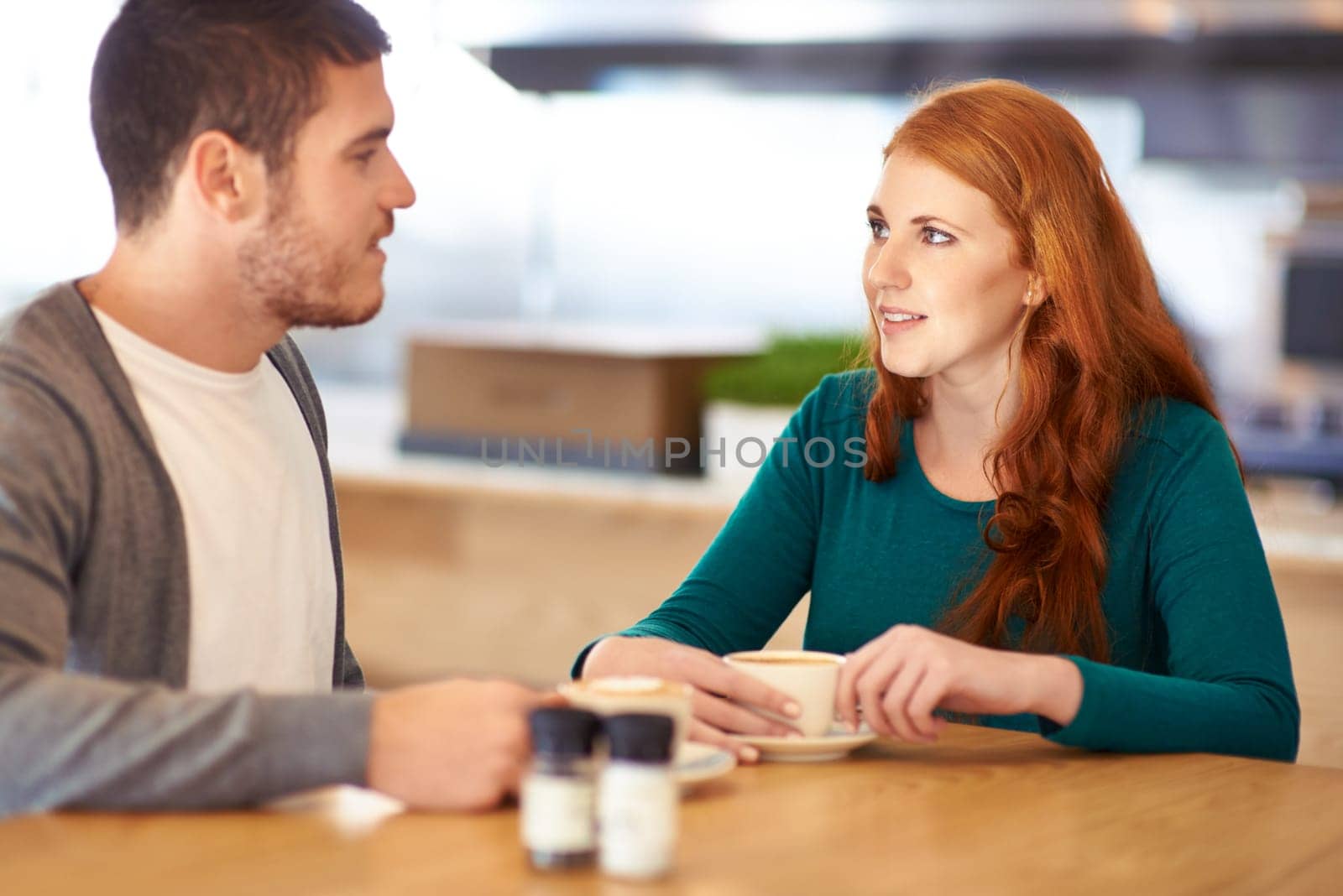 Restaurant, date and couple with coffee, love and conversation with romance and flirt. Cafe, man and woman with morning tea and bonding together with care and relationship with marriage and trust.