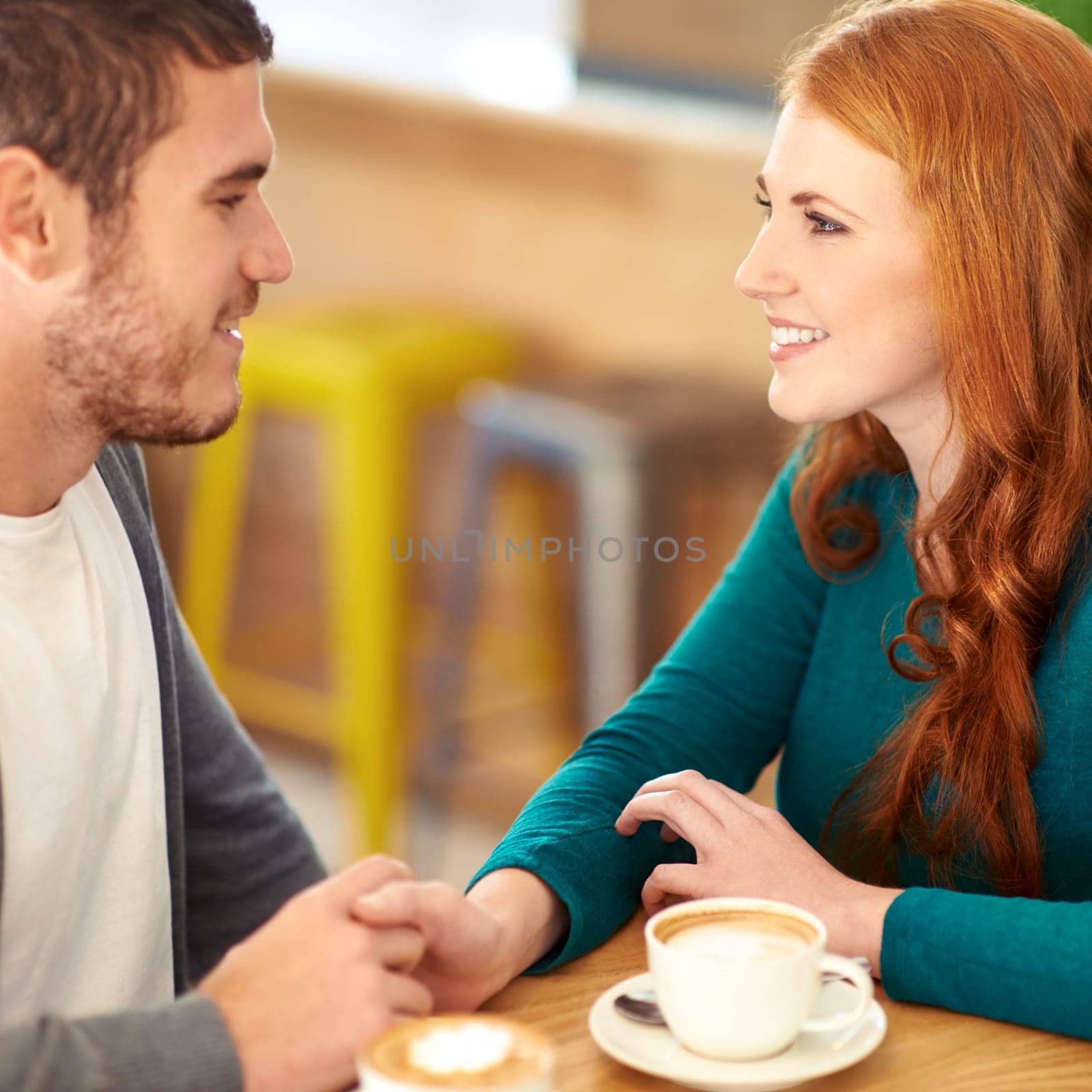 Restaurant, date and couple with coffee, holding hands and relationship with romance and flirt. Cafe, man and woman with cappuccino or bonding together with care or love with marriage, smile or trust.