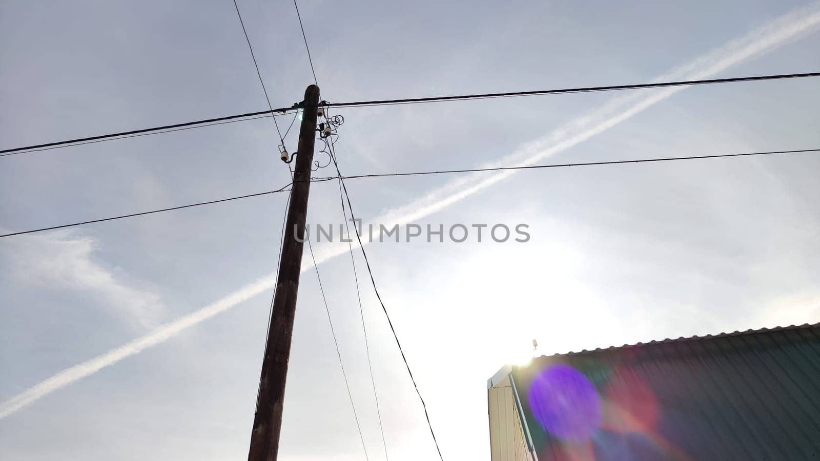 Old pole with wires against the sky. Electric transmission line, Eco-friendly energy