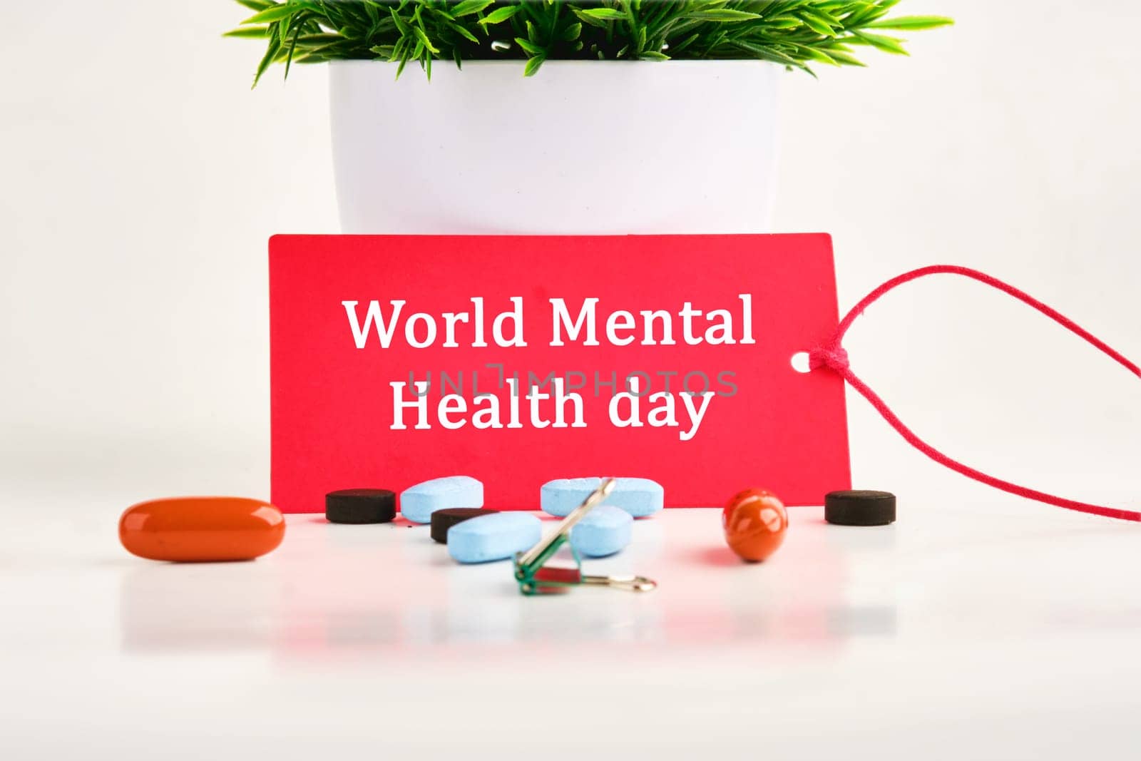 Depression and support concept. World mental health day on a red card with pills lying next to it