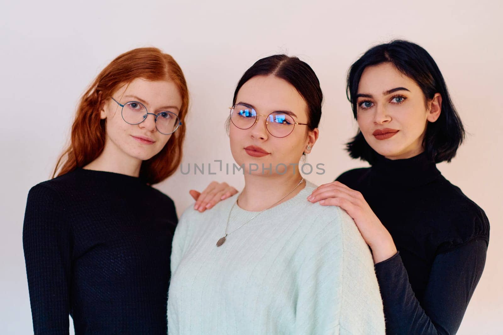 Familial love and unity as three sisters embrace each other against a pure white backdrop, symbolizing the enduring bond of sisterhood.