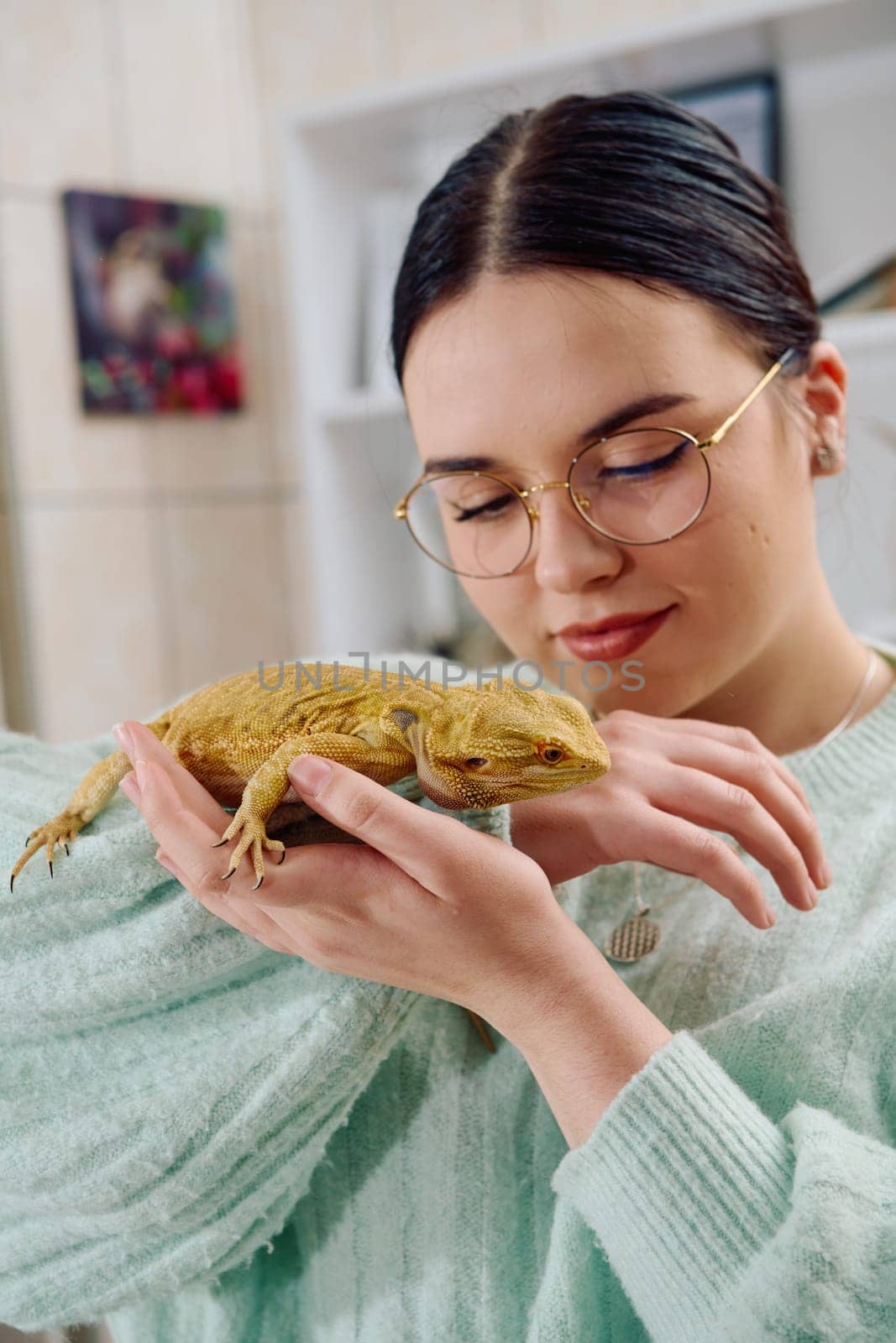 A beautiful woman in a joyful moment, posing with her adorable bearded dragon pets, radiating love and companionship.