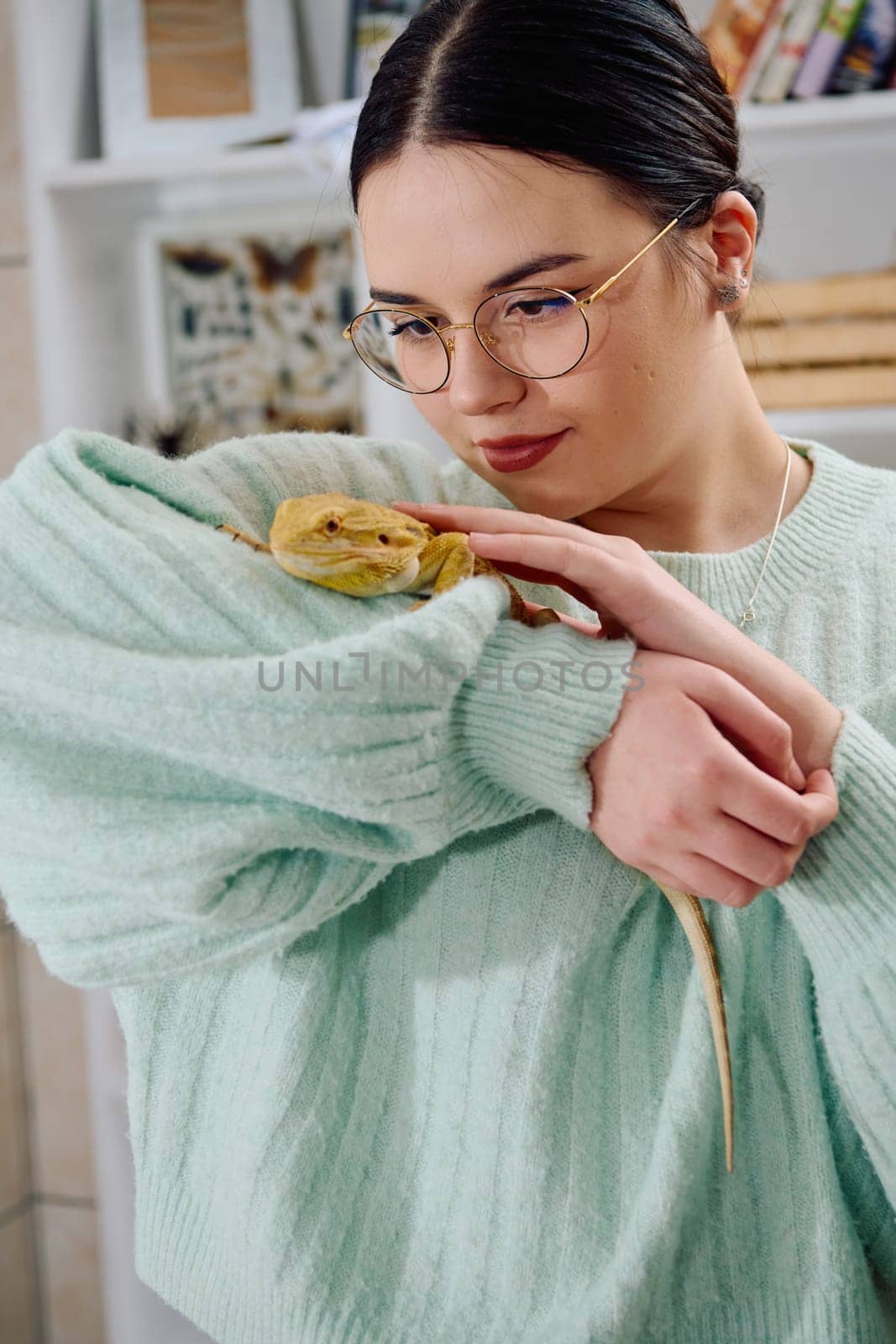 A beautiful woman in a joyful moment, posing with her adorable bearded dragon pets, radiating love and companionship.