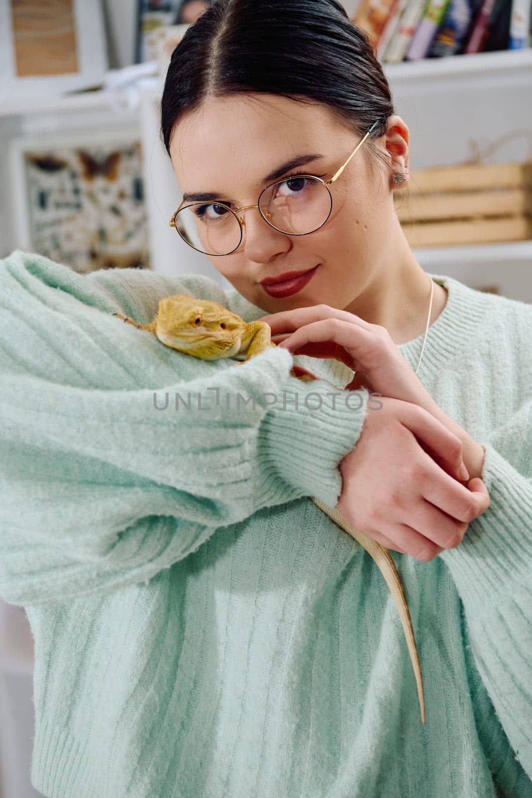 A beautiful woman in a joyful moment, posing with her adorable bearded dragon pets, radiating love and companionship.