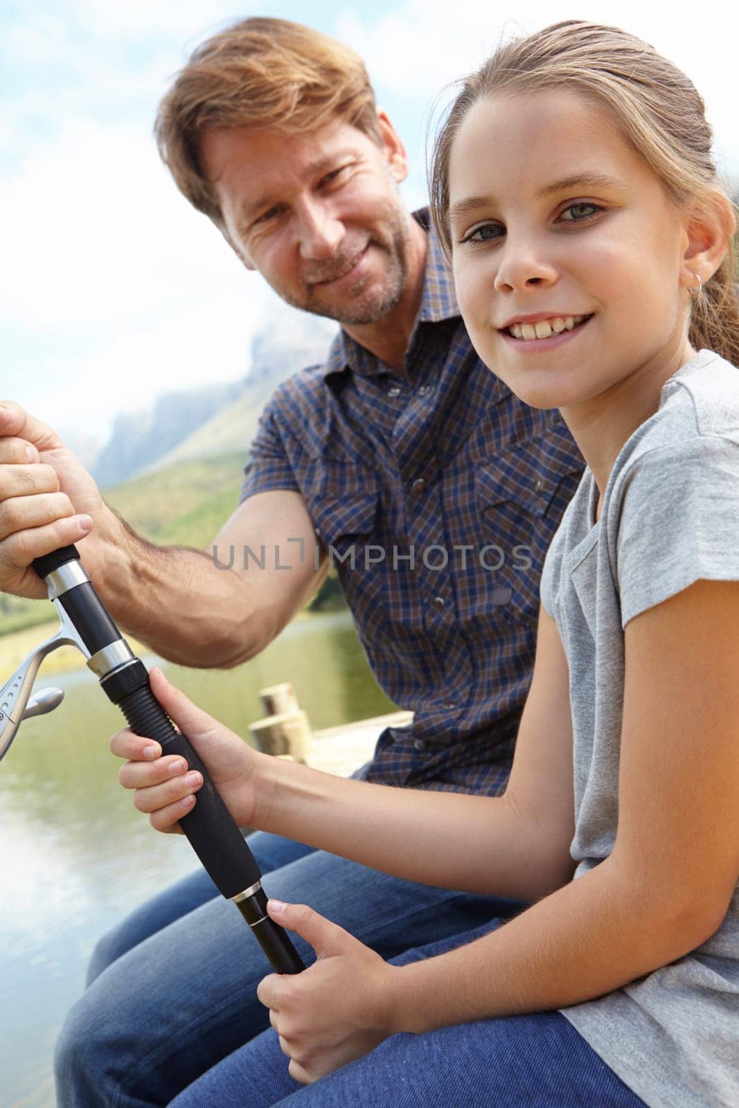 Father, kid and fishing in nature for teaching, learning and outdoor with holiday, travel or sustainable living in portrait. Happy family, dad or fisherman with girl by water or lake for adventure.
