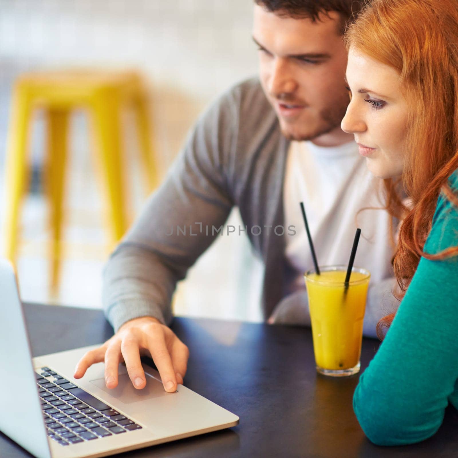 Couple, man and woman with laptop in cafe with connectivity, internet and drink juice together. People, dating and busy in restaurant with beverage, computer and online with technology for project.