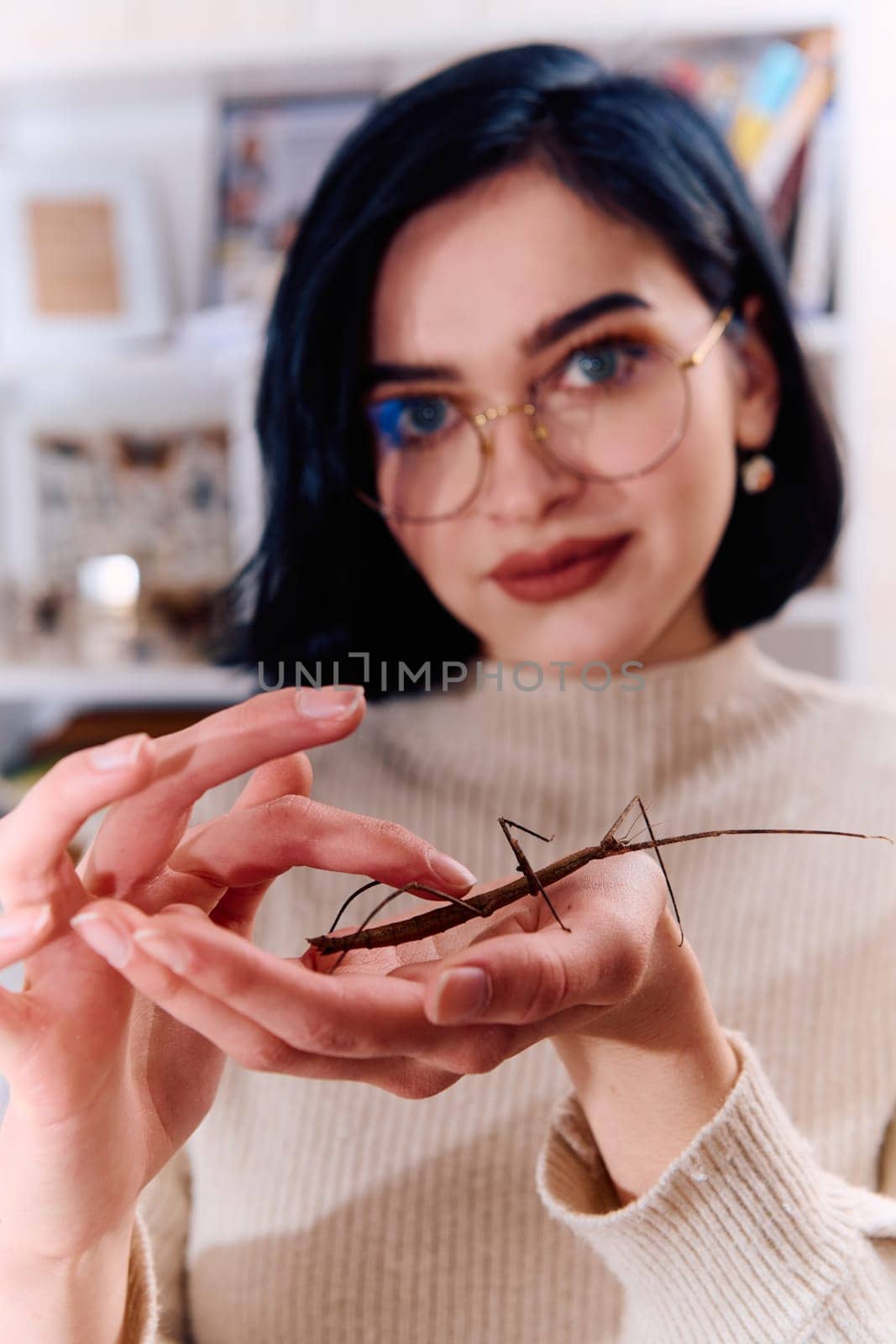 Young Woman Captured in a Beautiful Moment with Her Stick Insect (Medauroidea Extradentata) by dotshock