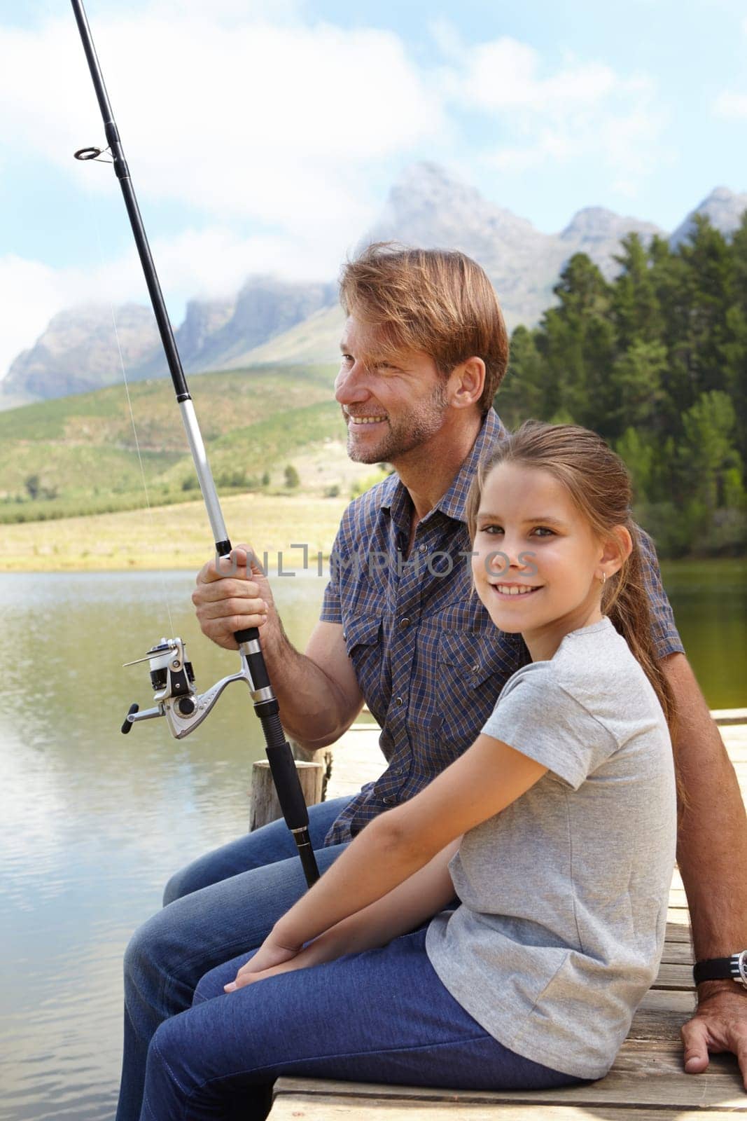 Father, child and fishing in nature for teaching, learning and outdoor with holiday, travel or sustainable living in portrait. Happy family, dad or fisherman with girl by water or lake for adventure by YuriArcurs