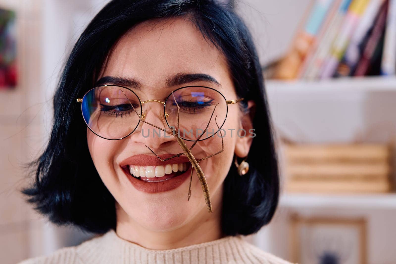 A serene moment as a young woman poses with her beloved stick insect, showcasing the unique bond between human and arachnid.