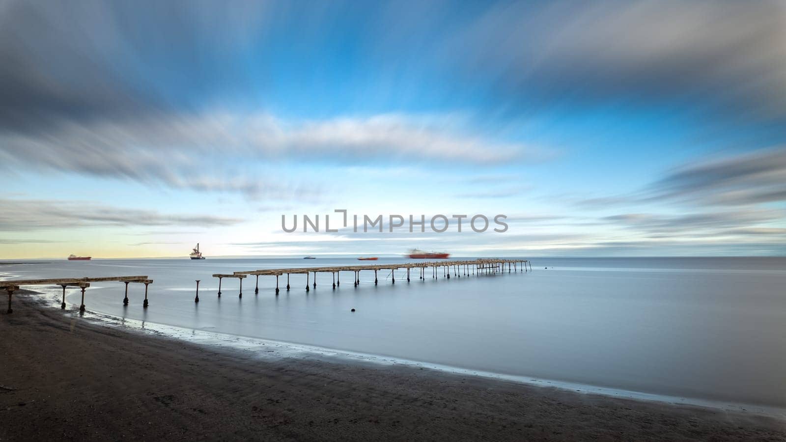 Serene seascape with long pier under a dynamic sky by FerradalFCG