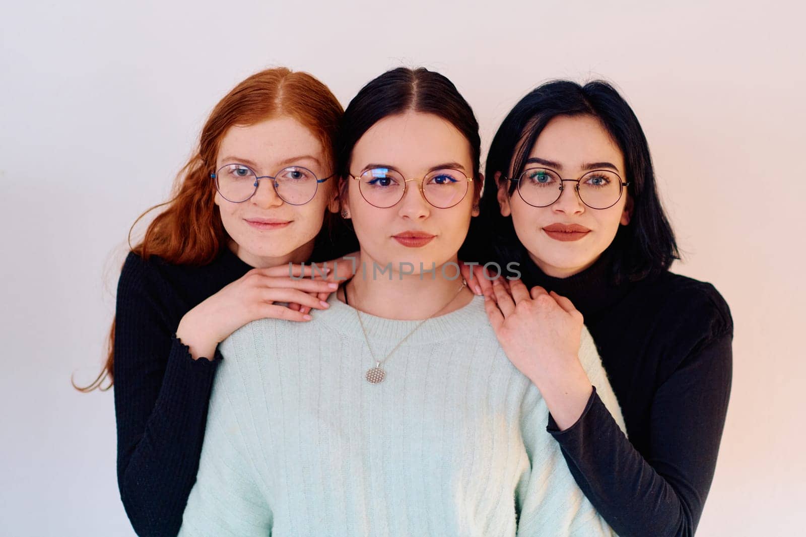 Familial love and unity as three sisters embrace each other against a pure white backdrop, symbolizing the enduring bond of sisterhood.