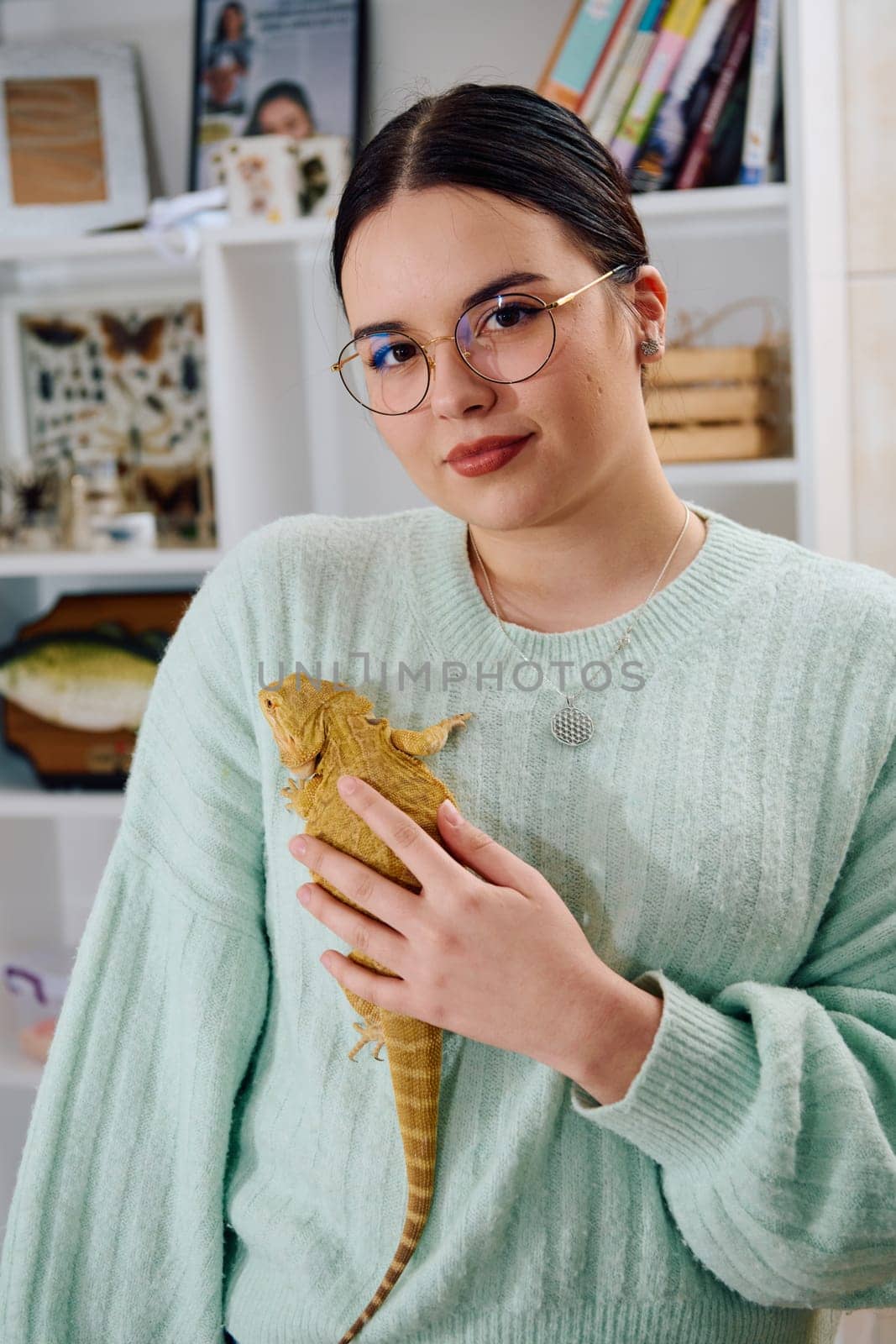 A beautiful woman in a joyful moment, posing with her adorable bearded dragon pets, radiating love and companionship.