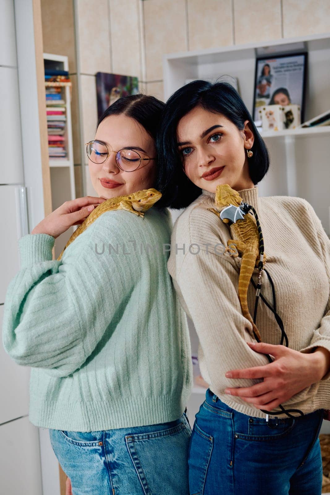 The sisters' smiles and the lizard's calm demeanor suggest that they are all enjoying each other's company.