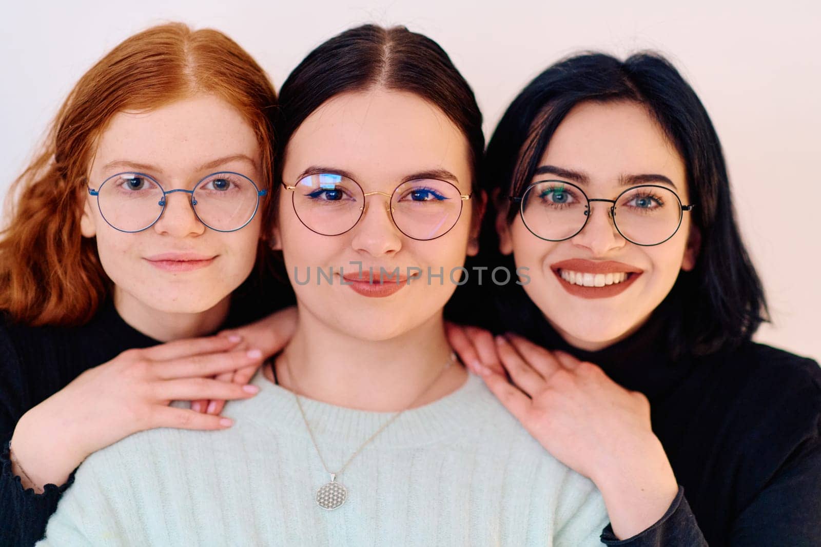 Familial love and unity as three sisters embrace each other against a pure white backdrop, symbolizing the enduring bond of sisterhood.