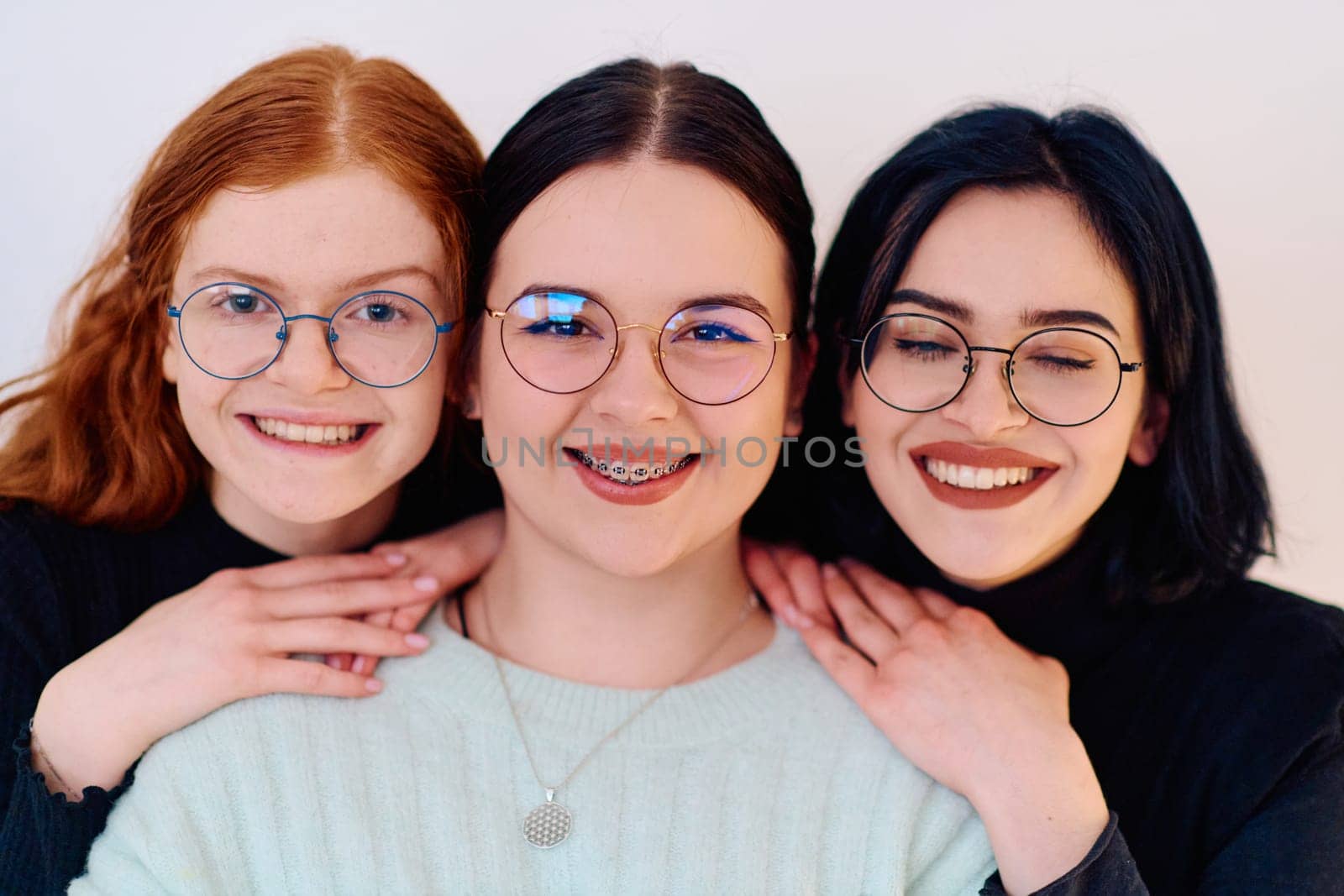 Familial love and unity as three sisters embrace each other against a pure white backdrop, symbolizing the enduring bond of sisterhood.