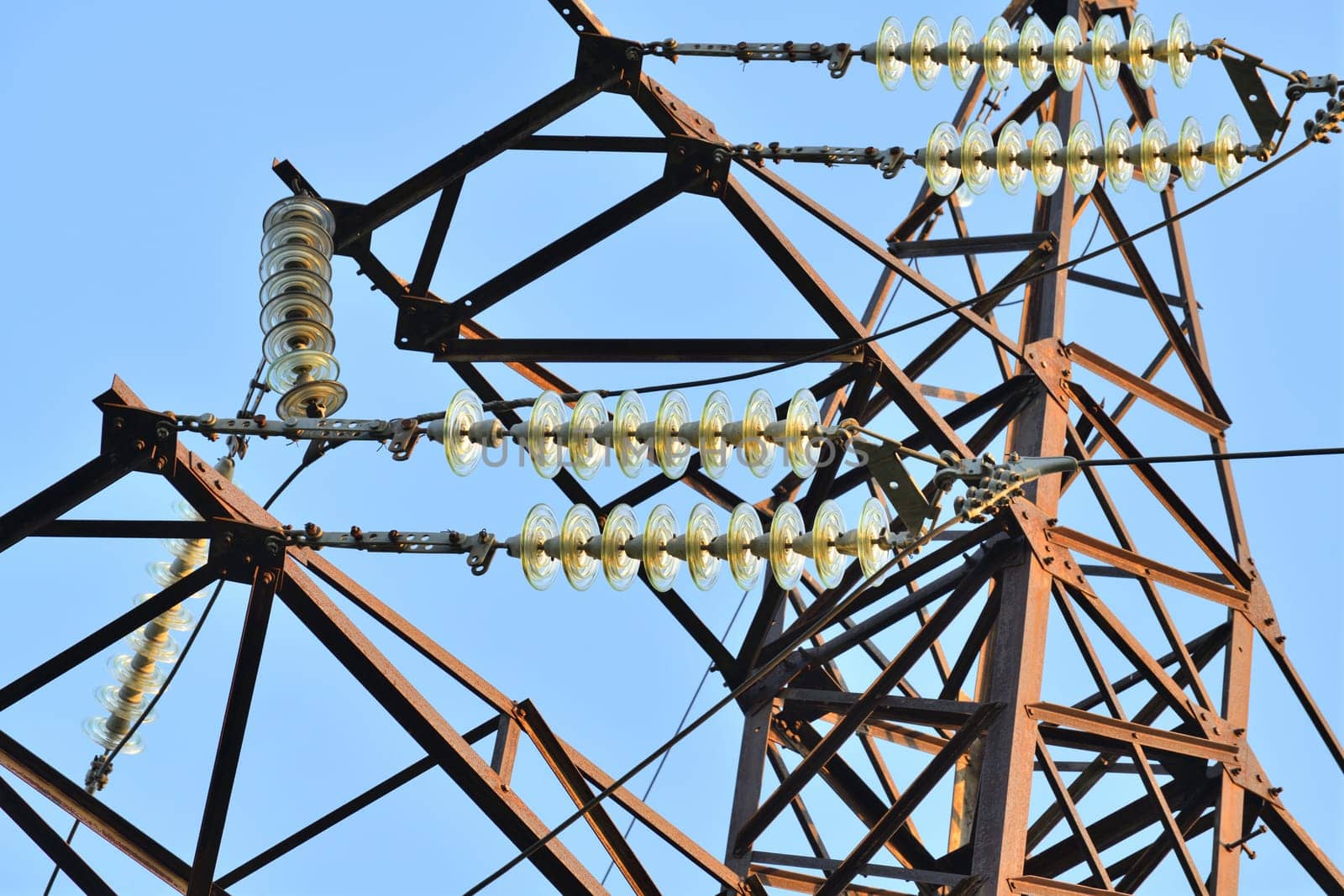 Overhead power transmission towers with ceramic and glass line insulators by olgavolodina