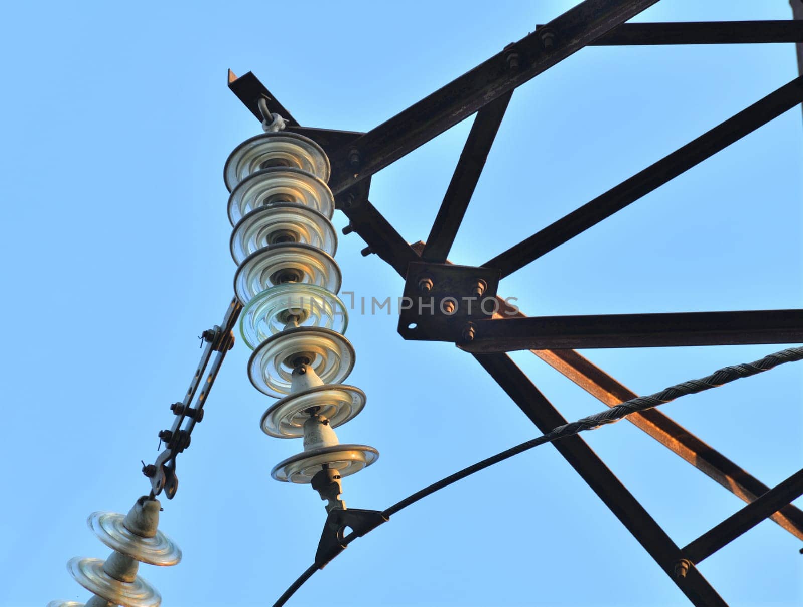 Overhead power transmission towers with ceramic and glass line insulators by olgavolodina