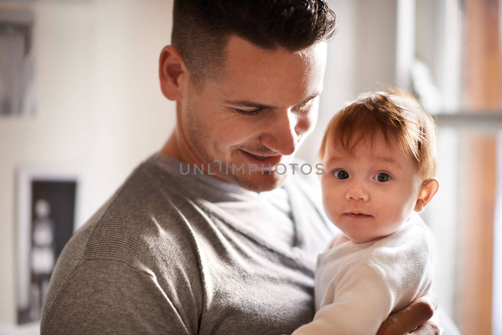 Father, baby and home portrait with bonding, love and support together with family care and development. Dad, smile and young child in a house with parent with a kid and happy about toddler growth.