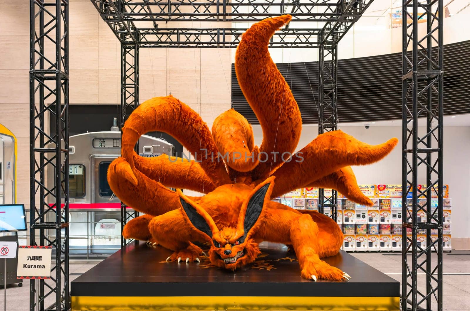 ikebukuro, japan - jan 16 2024: Life-size plush toy featuring the giant manga hero Kurama or Nine-Tails, a fierce fox in Naruto Shippuden displayed in the free exhibition hall of Tokyo Anime Station.