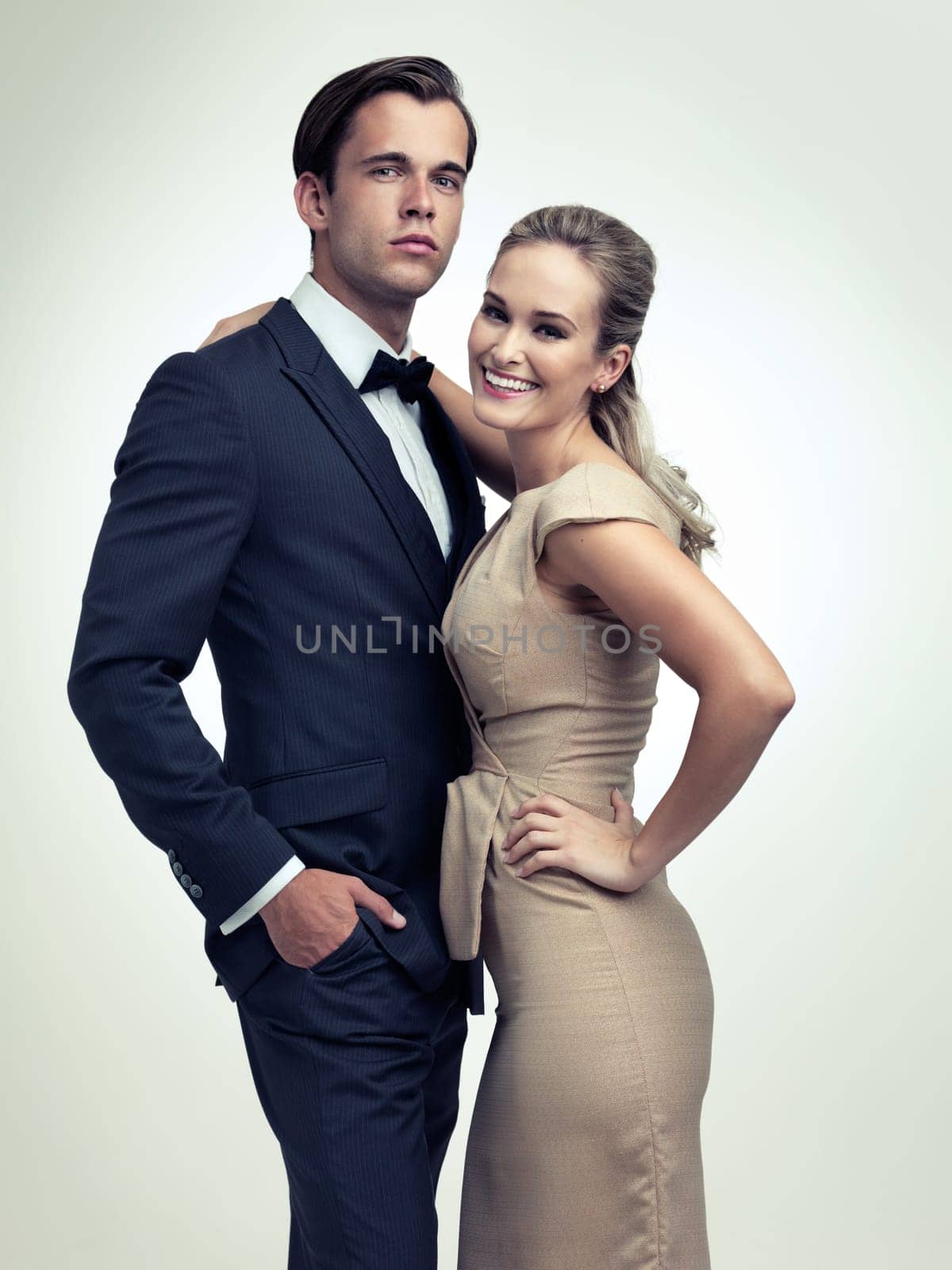 Couple, studio and portrait with smile, vintage and fashion for rich retro romance. Man, woman and model with tuxedo, glamour and confidence for classy black tie event isolated on white background.