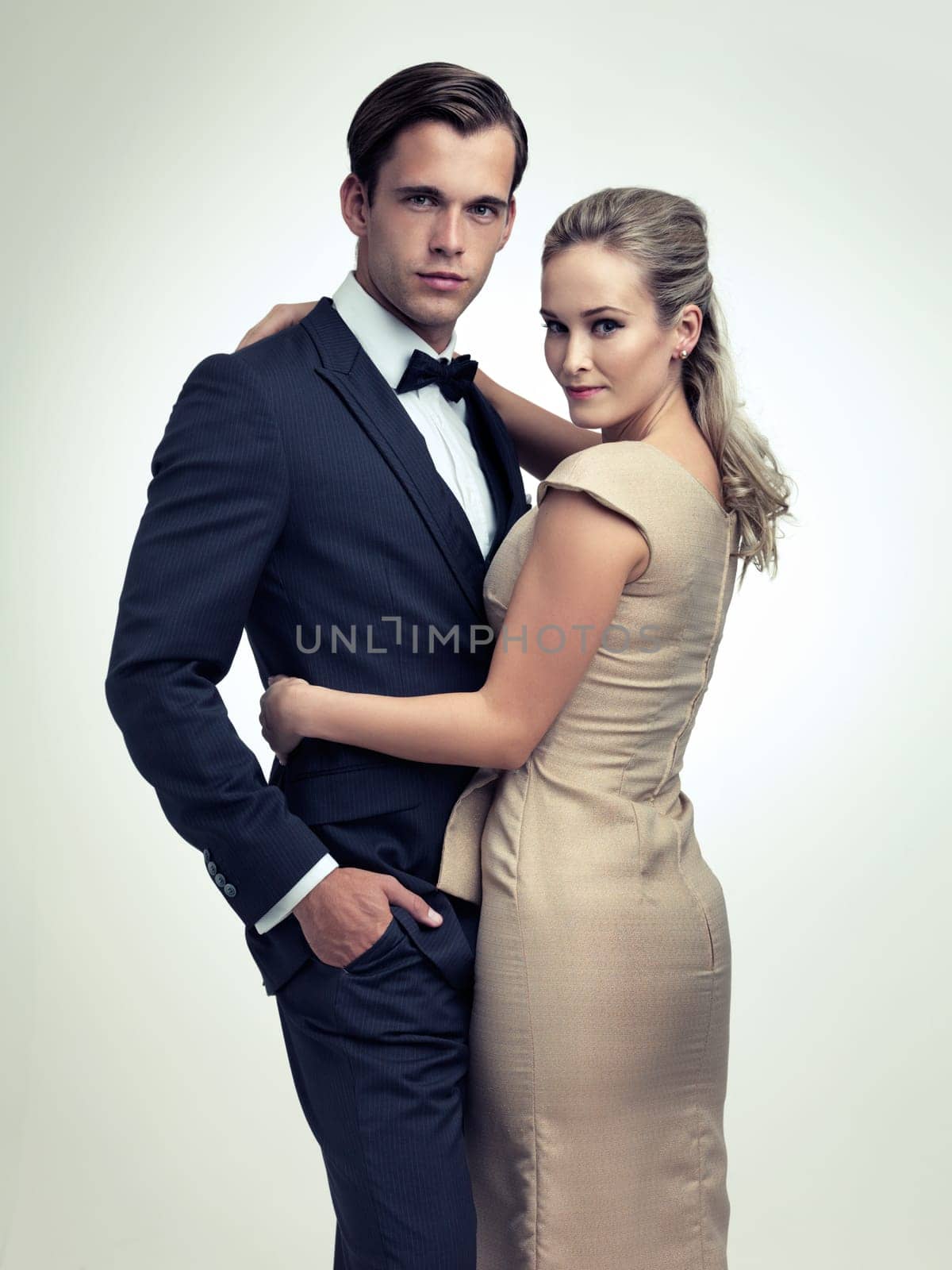 Couple, studio and portrait with luxury, vintage and fashion for rich retro romance. Man, woman and model with tuxedo, glamour and confidence for classy black tie event isolated on white background.