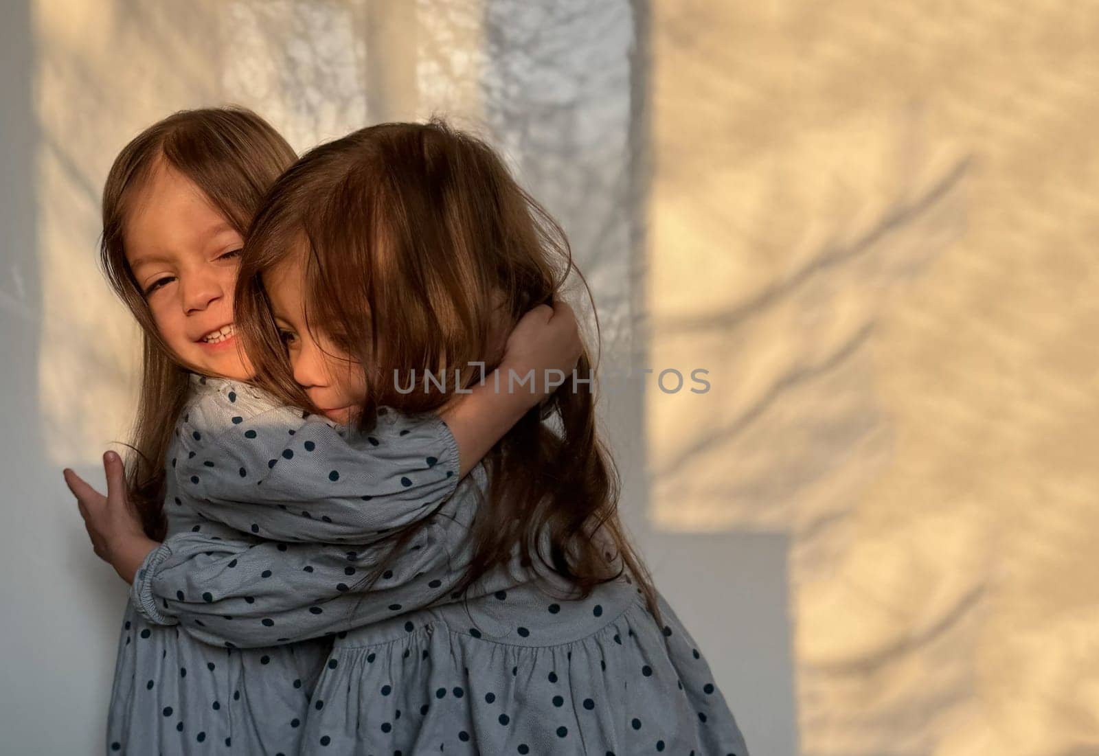 Portrait of mixed race twin baby girls hugging each other. Happy siblings day. by Ri6ka