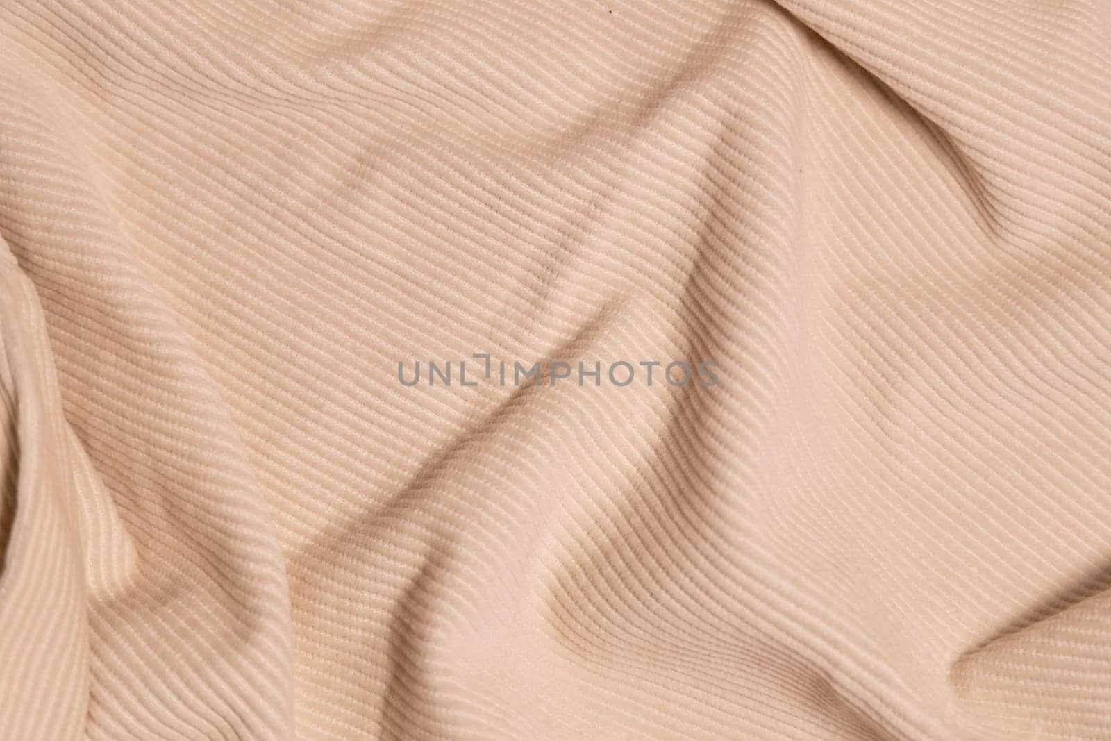 Velvety fabric texture pattern. Texture of velvet textile nude color