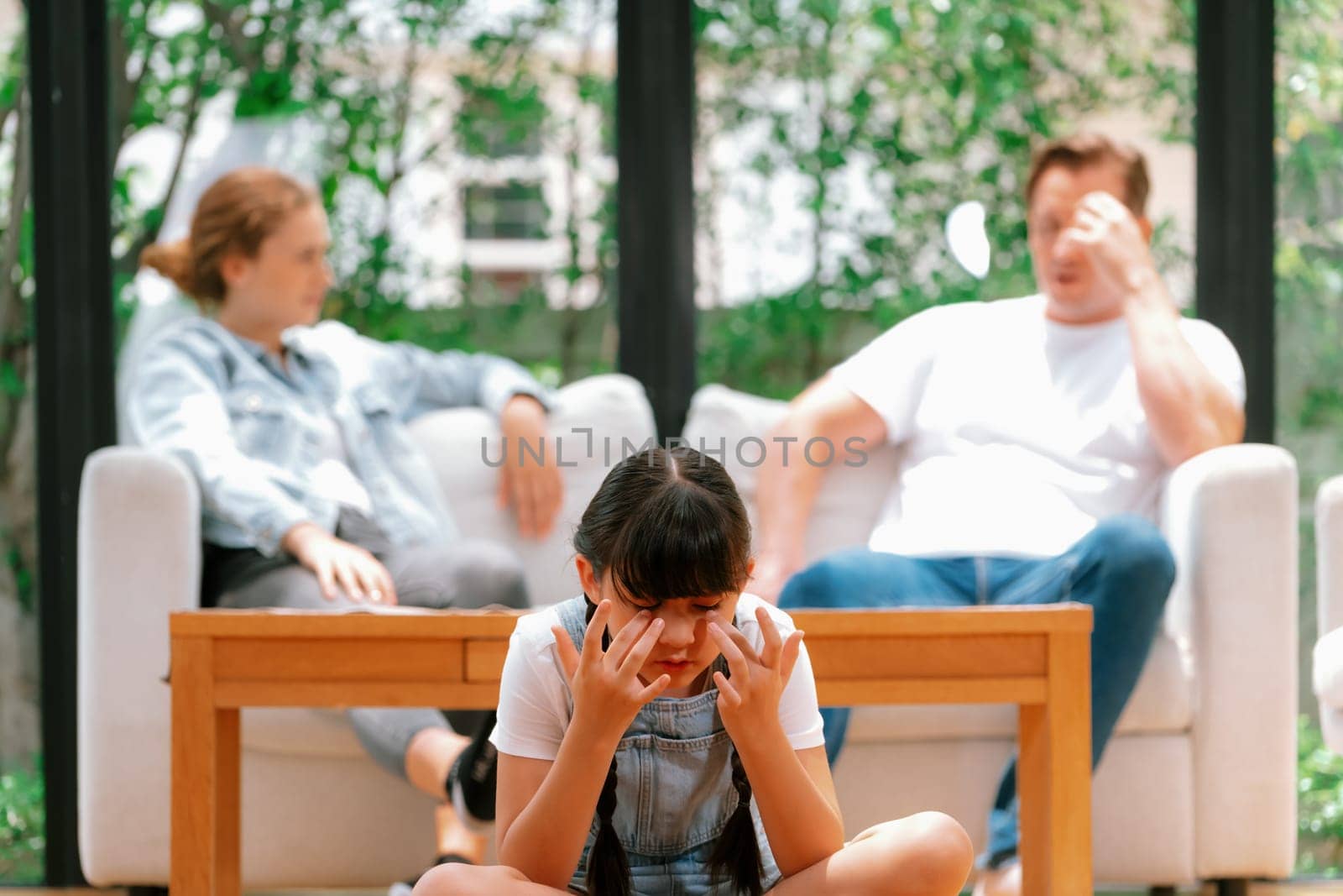 Young girl trapped in the middle of tension by her parent argument. Synchronos by biancoblue