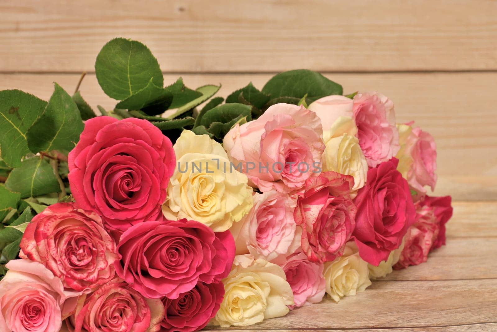 bouquet of yellow and pink roses lies on the table